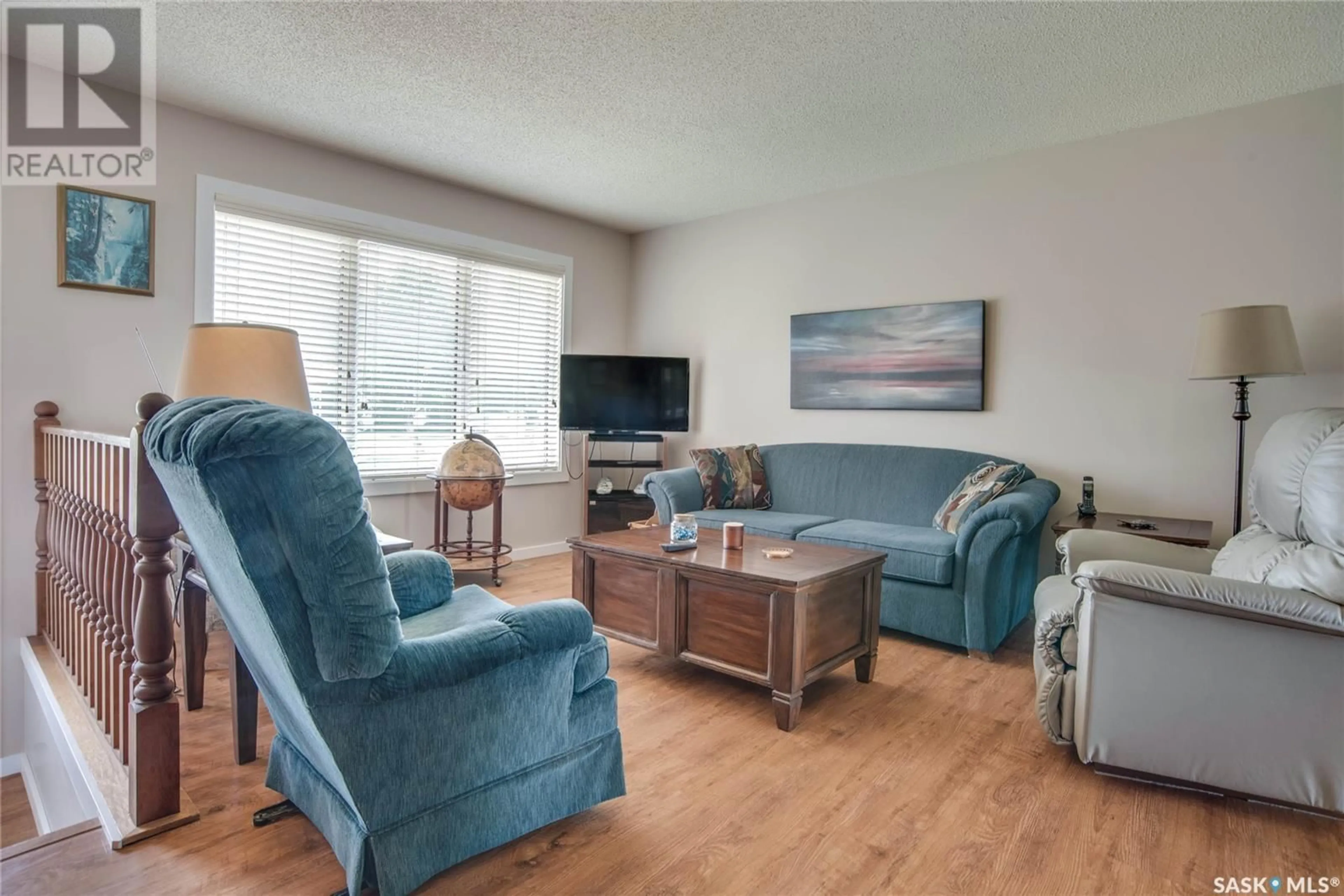 Living room with furniture, wood/laminate floor for 306 HASLAM CRESCENT, Saskatoon Saskatchewan S7S1E4