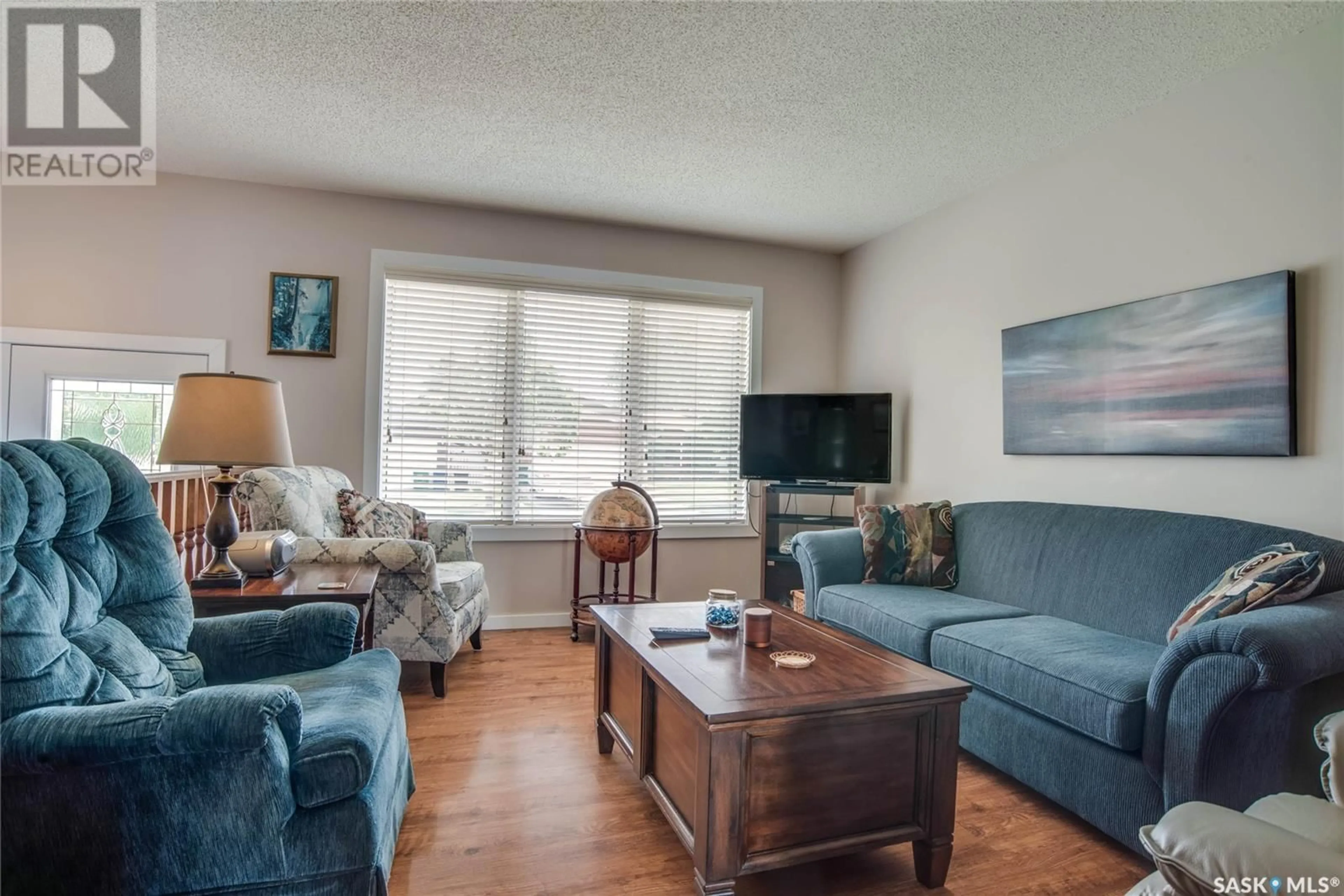 Living room with furniture, wood/laminate floor for 306 HASLAM CRESCENT, Saskatoon Saskatchewan S7S1E4