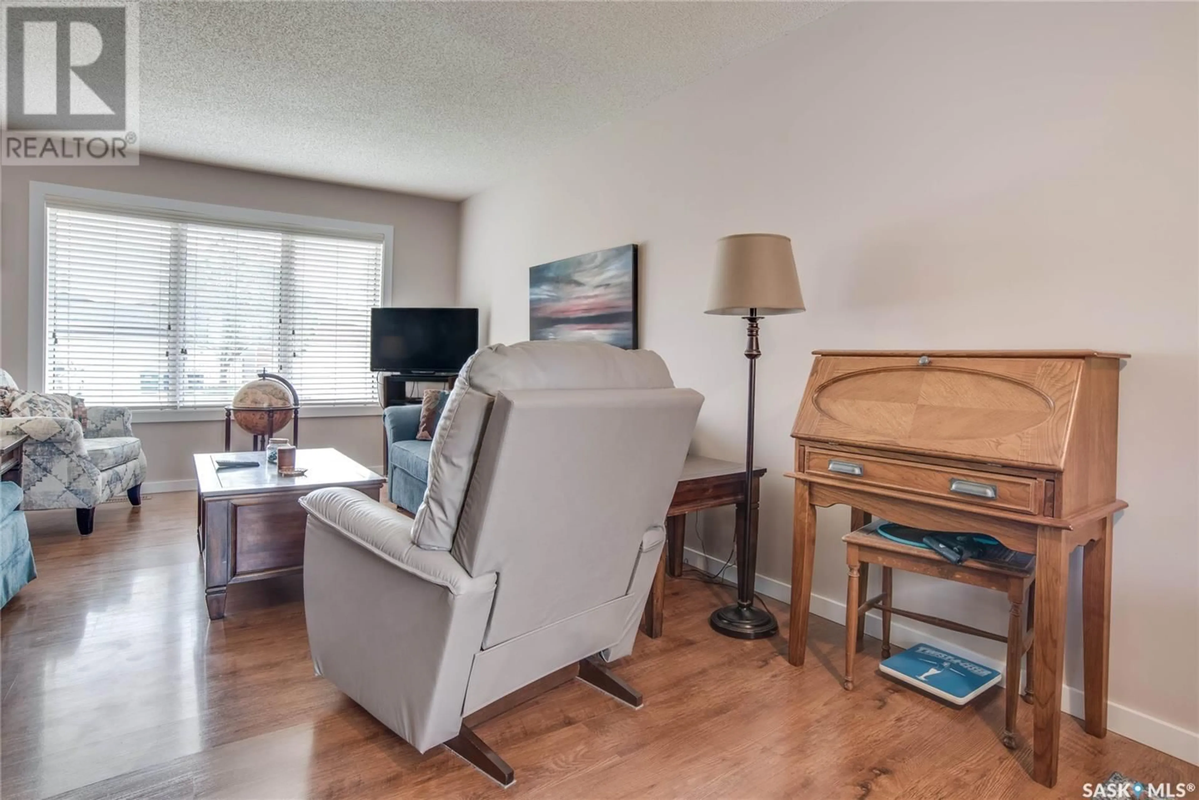 Living room with furniture, wood/laminate floor for 306 HASLAM CRESCENT, Saskatoon Saskatchewan S7S1E4