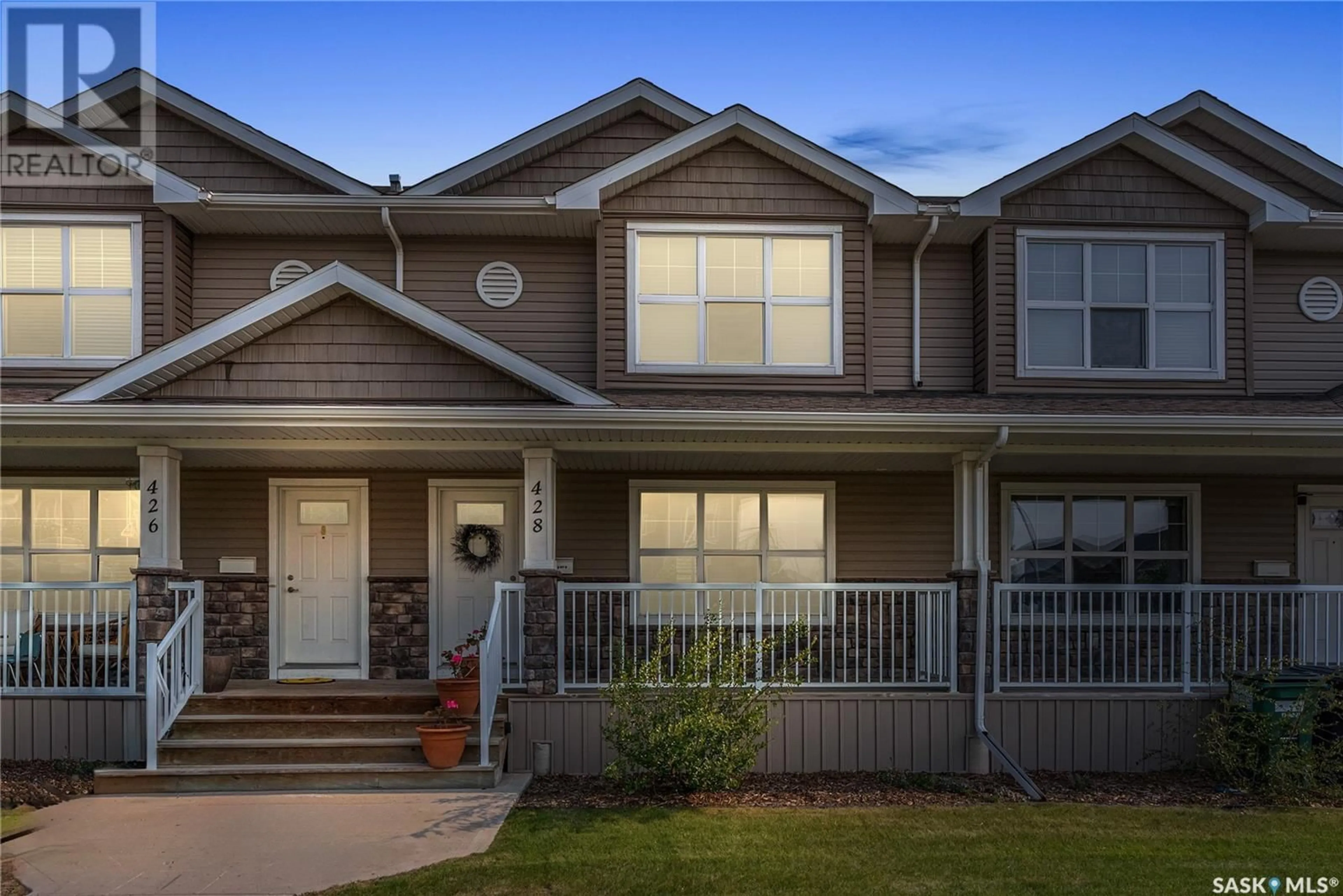 Home with vinyl exterior material, street for 428 MANINGAS BEND, Saskatoon Saskatchewan S7W0V6