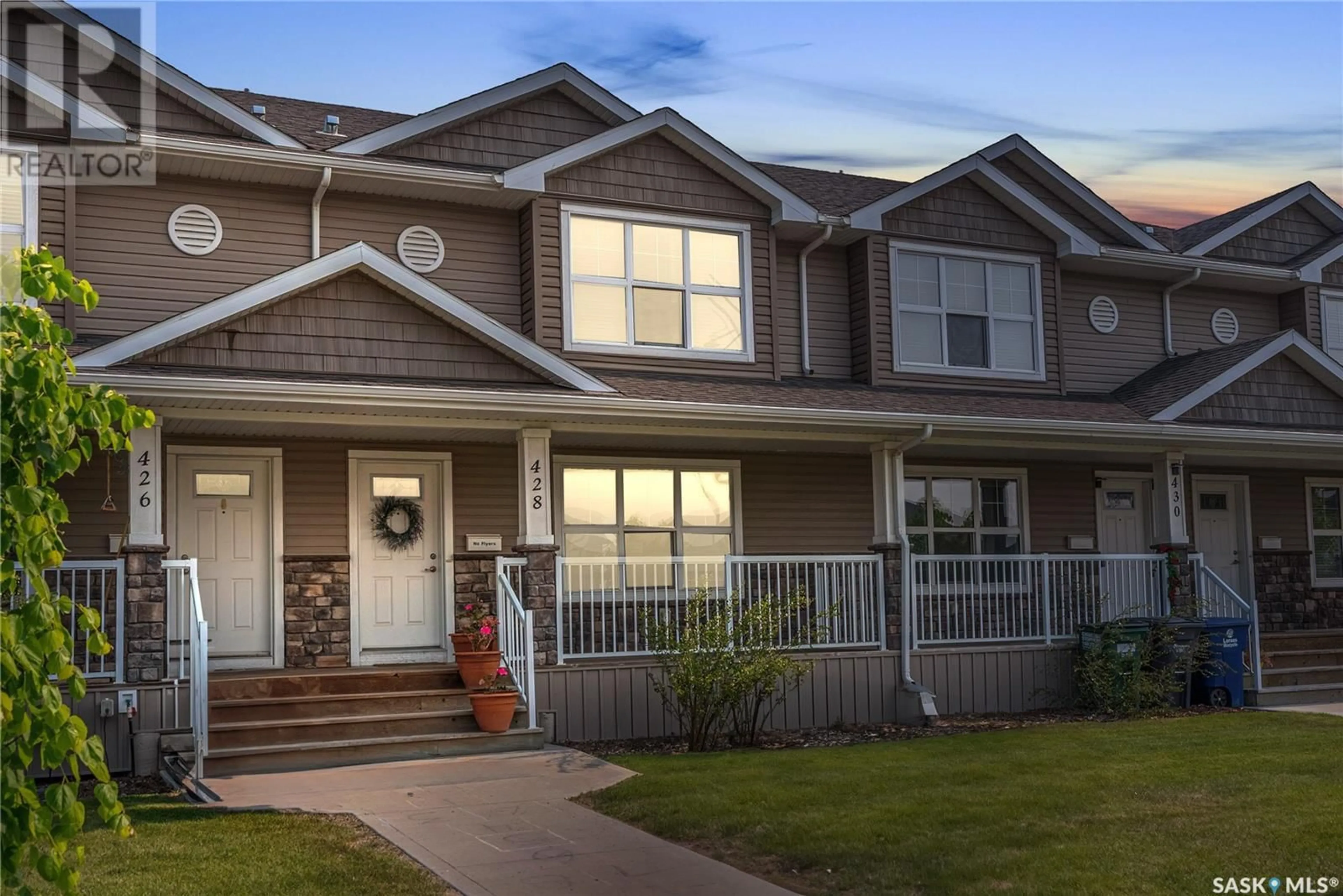 Home with vinyl exterior material, street for 428 MANINGAS BEND, Saskatoon Saskatchewan S7W0V6