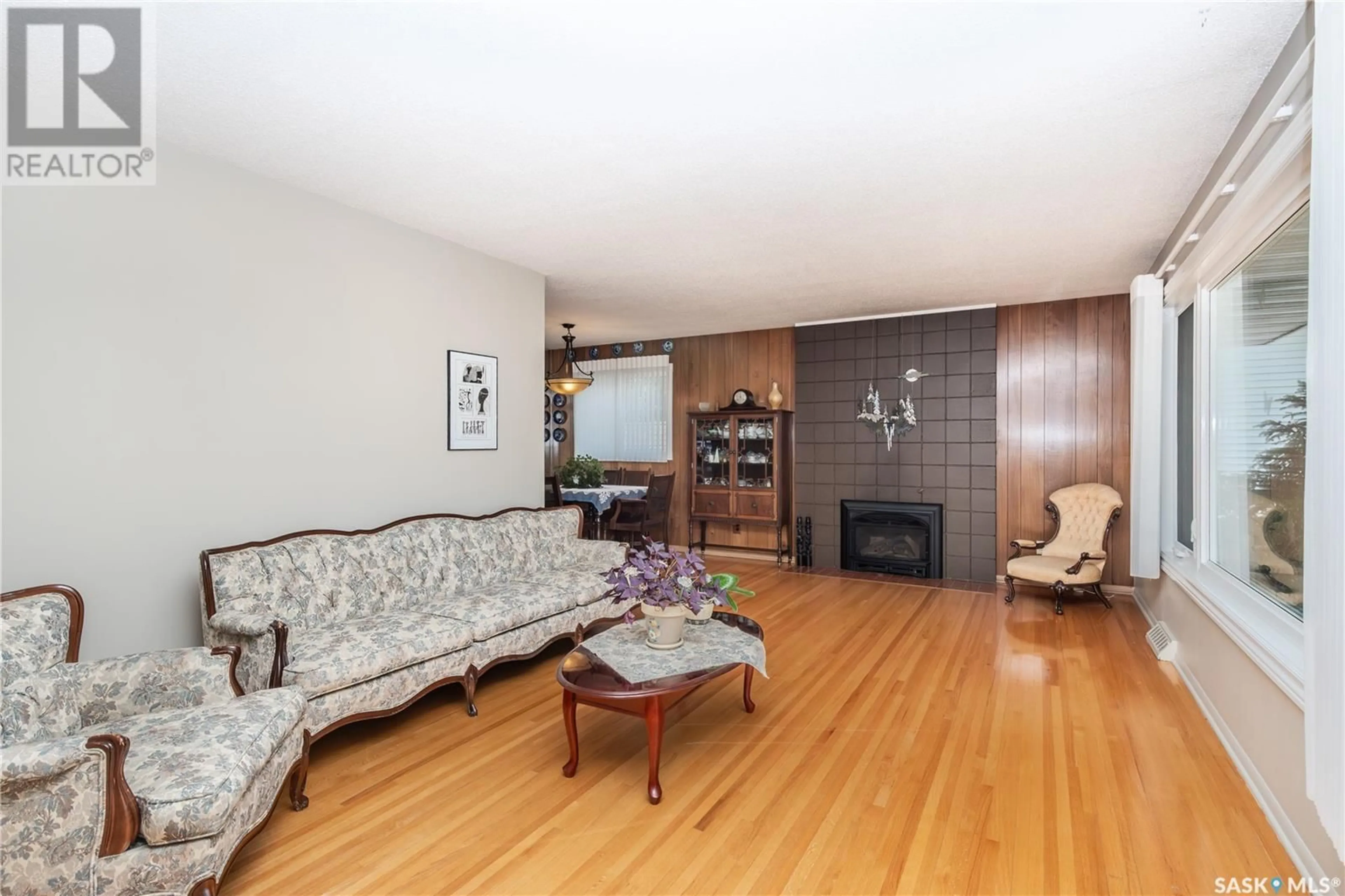 Living room with furniture, wood/laminate floor for 1813 MADDEN AVENUE, Saskatoon Saskatchewan S7H3M7