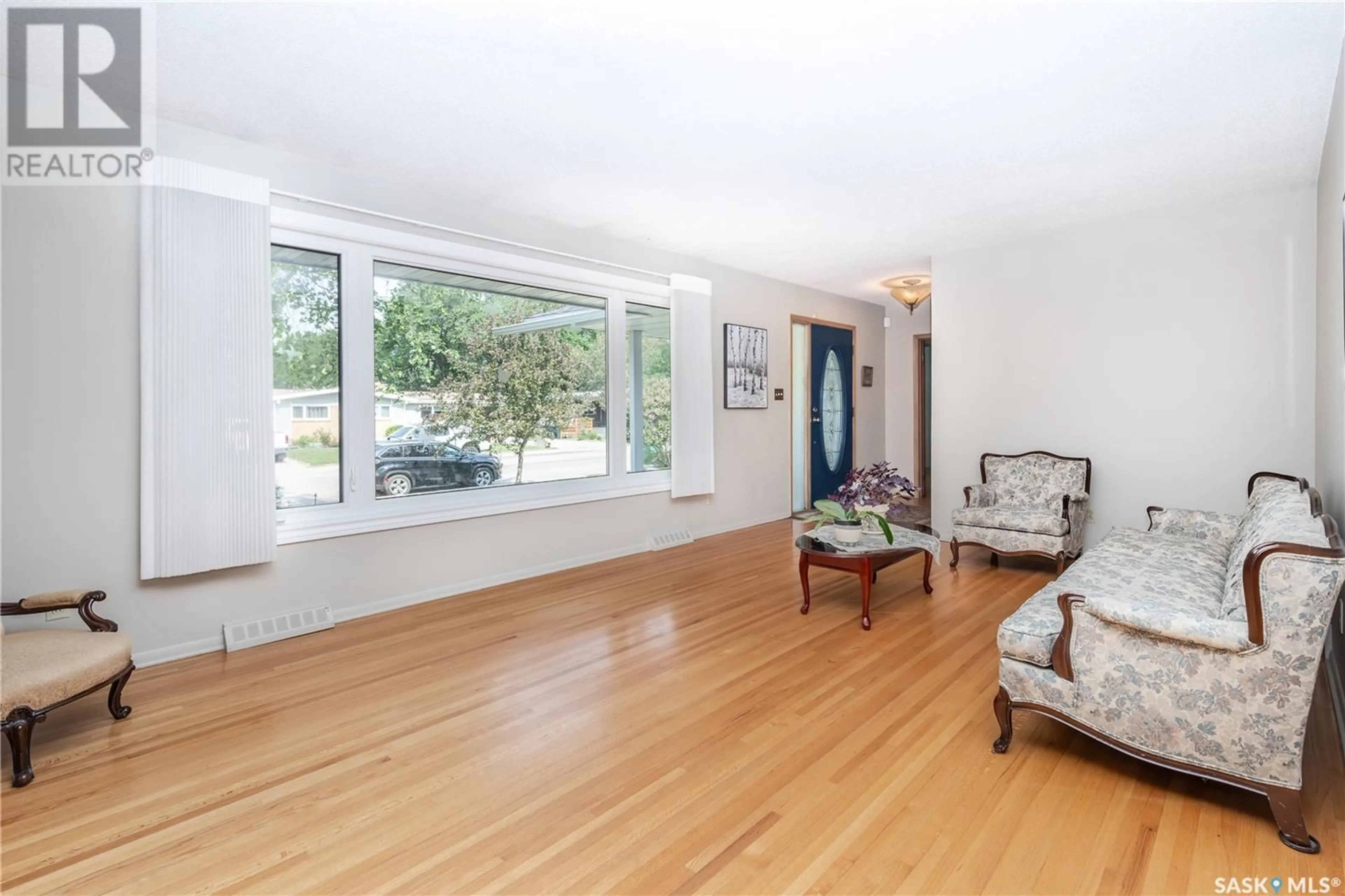 Living room with furniture, wood/laminate floor for 1813 MADDEN AVENUE, Saskatoon Saskatchewan S7H3M7