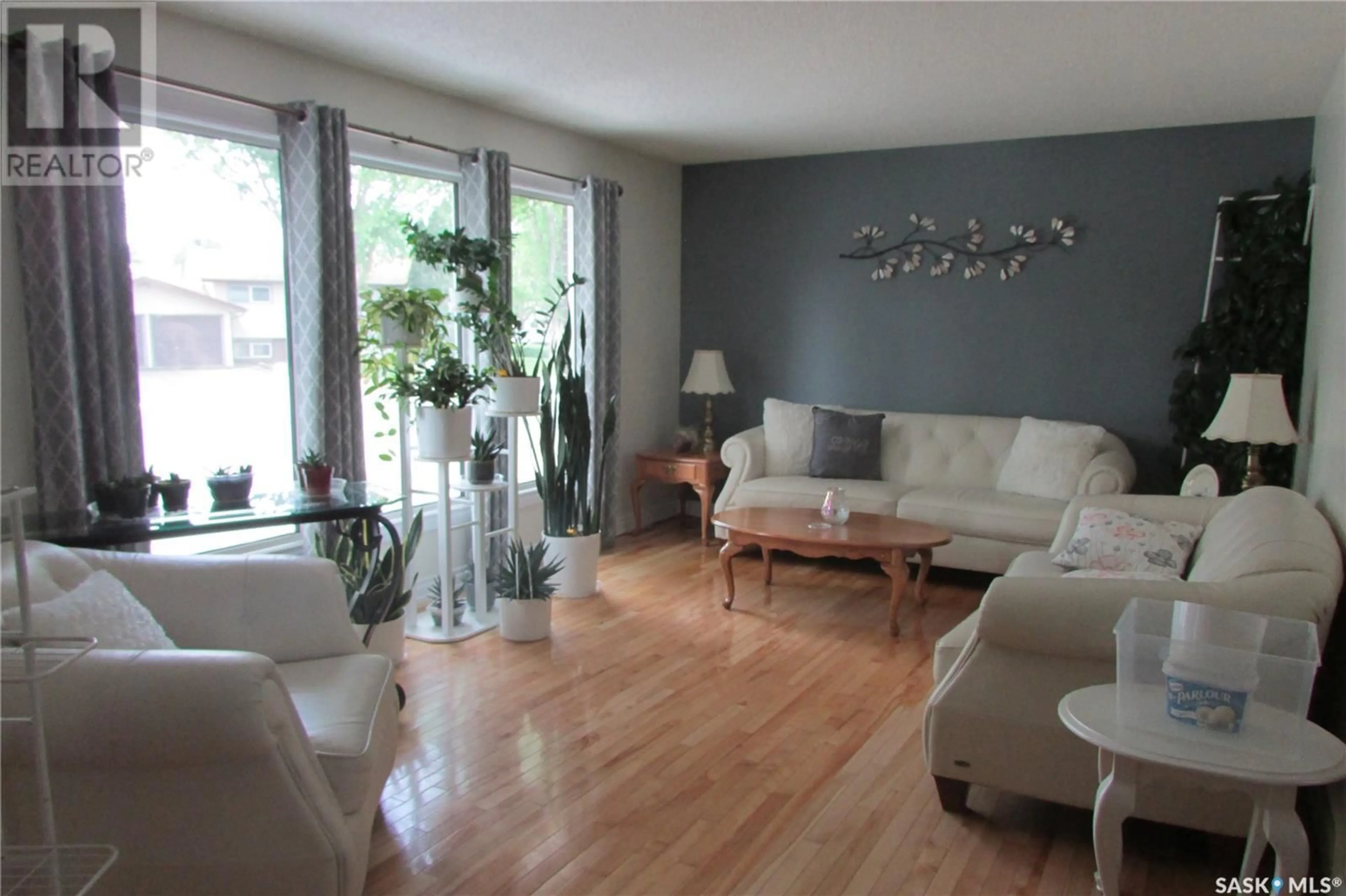Living room with furniture, wood/laminate floor for 227 RODENBUSH DRIVE, Regina Saskatchewan S4R6X1