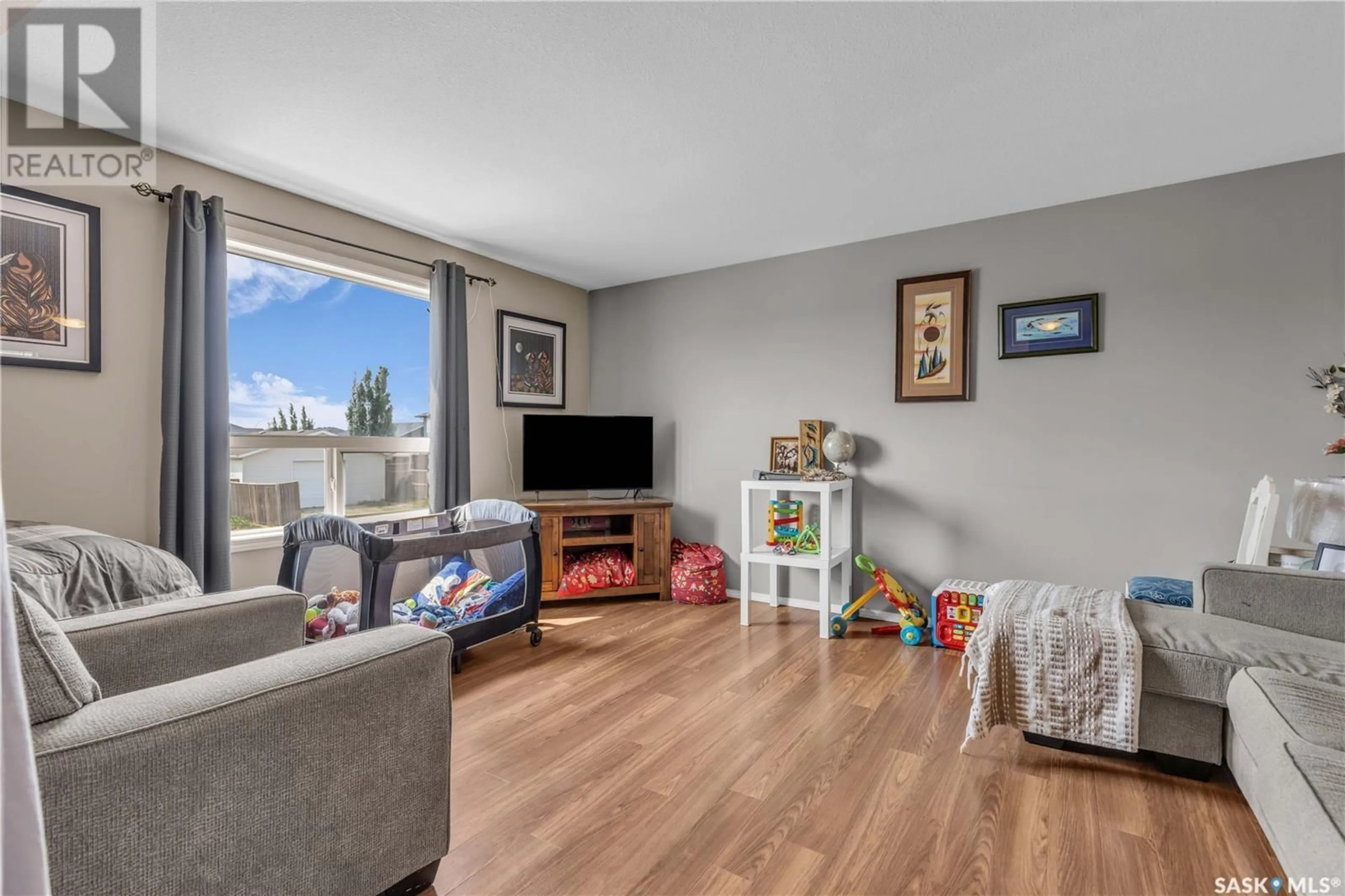Living room with furniture, wood/laminate floor for 8 200 HIEBERT CRESCENT, Martensville Saskatchewan S0K2T2