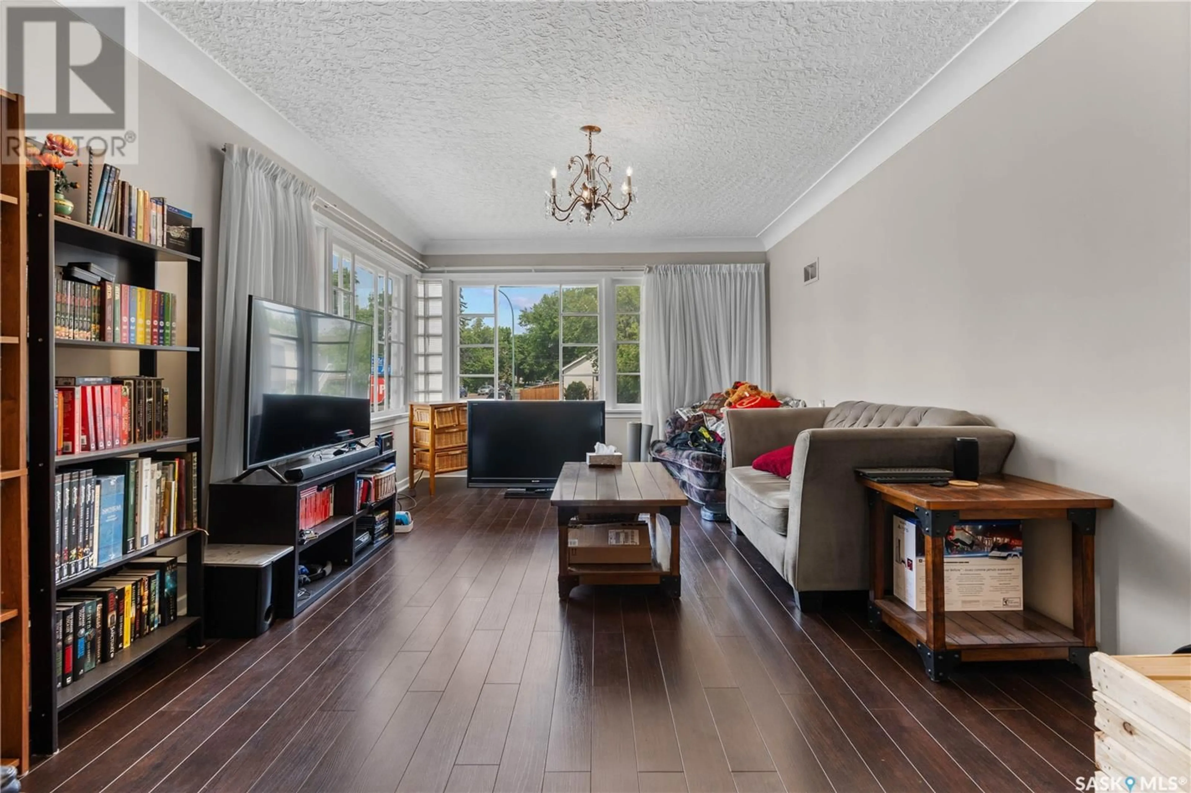 Living room with furniture, wood/laminate floor for 135 COLLEGE AVENUE, Regina Saskatchewan S4N0W4