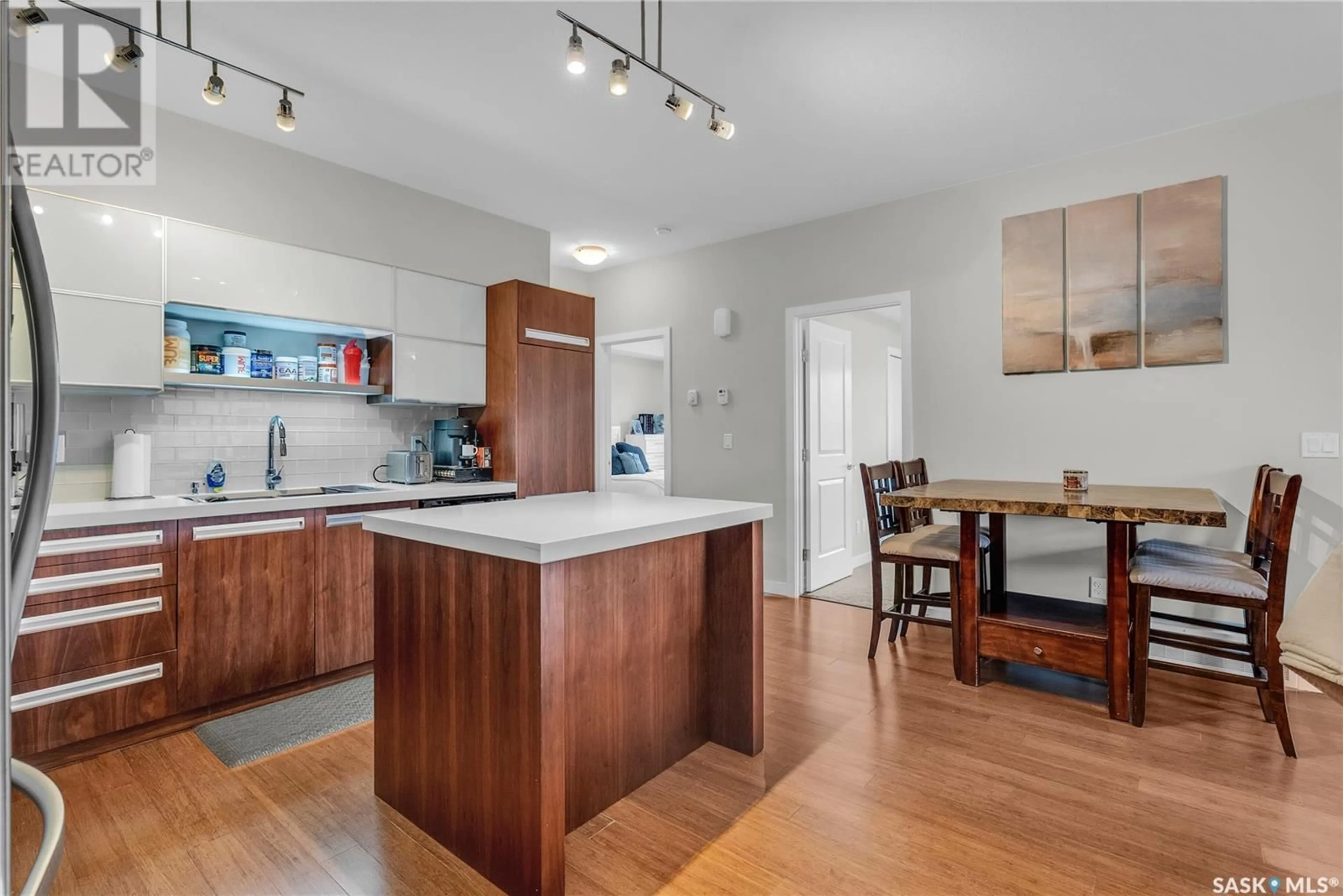 Open concept kitchen, wood/laminate floor for 1015 - 1904 PATRICK CRESCENT, Saskatoon Saskatchewan S7W0M5