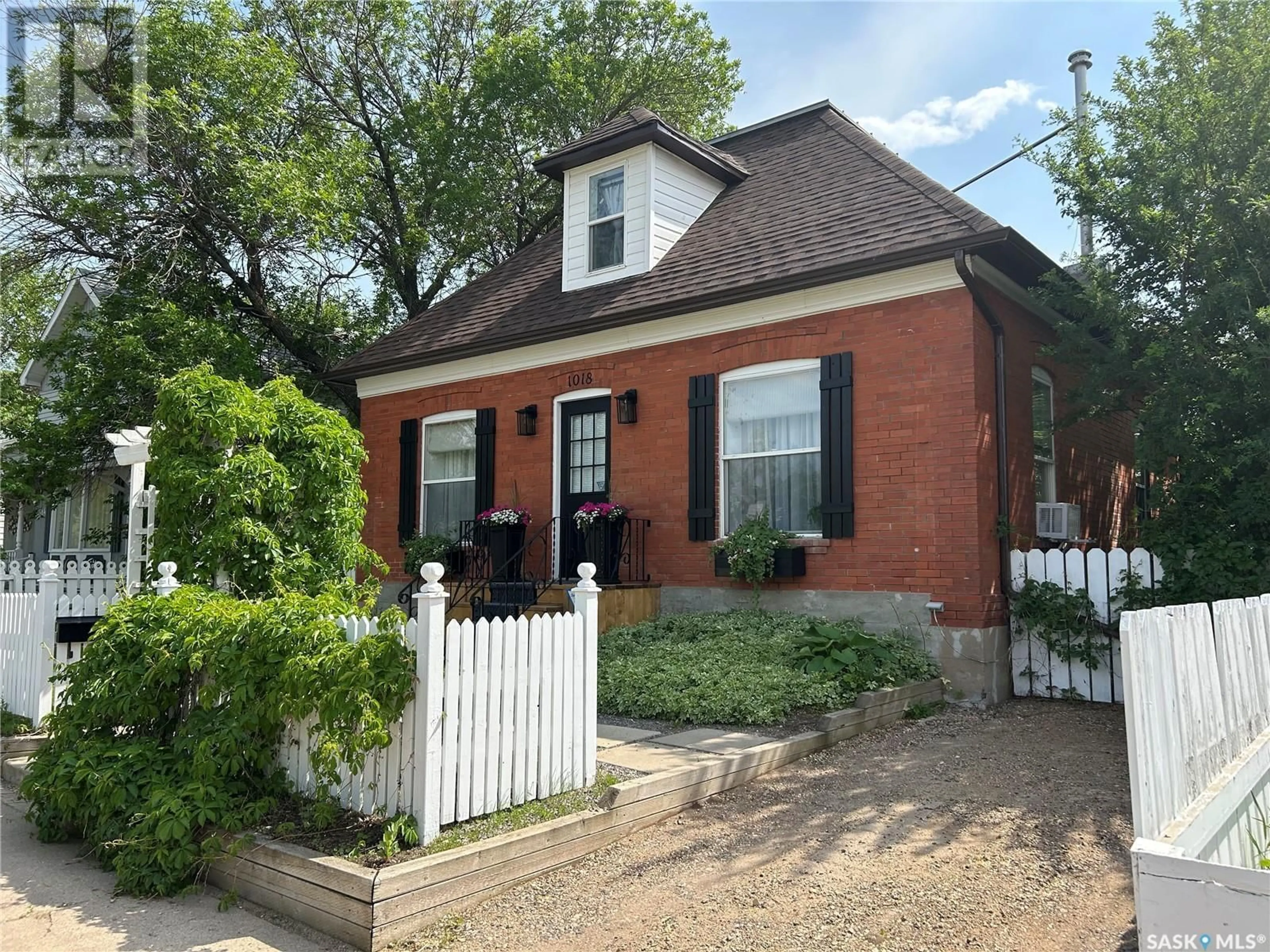 Home with brick exterior material, street for 1018 3RD STREET, Estevan Saskatchewan S4A0R5