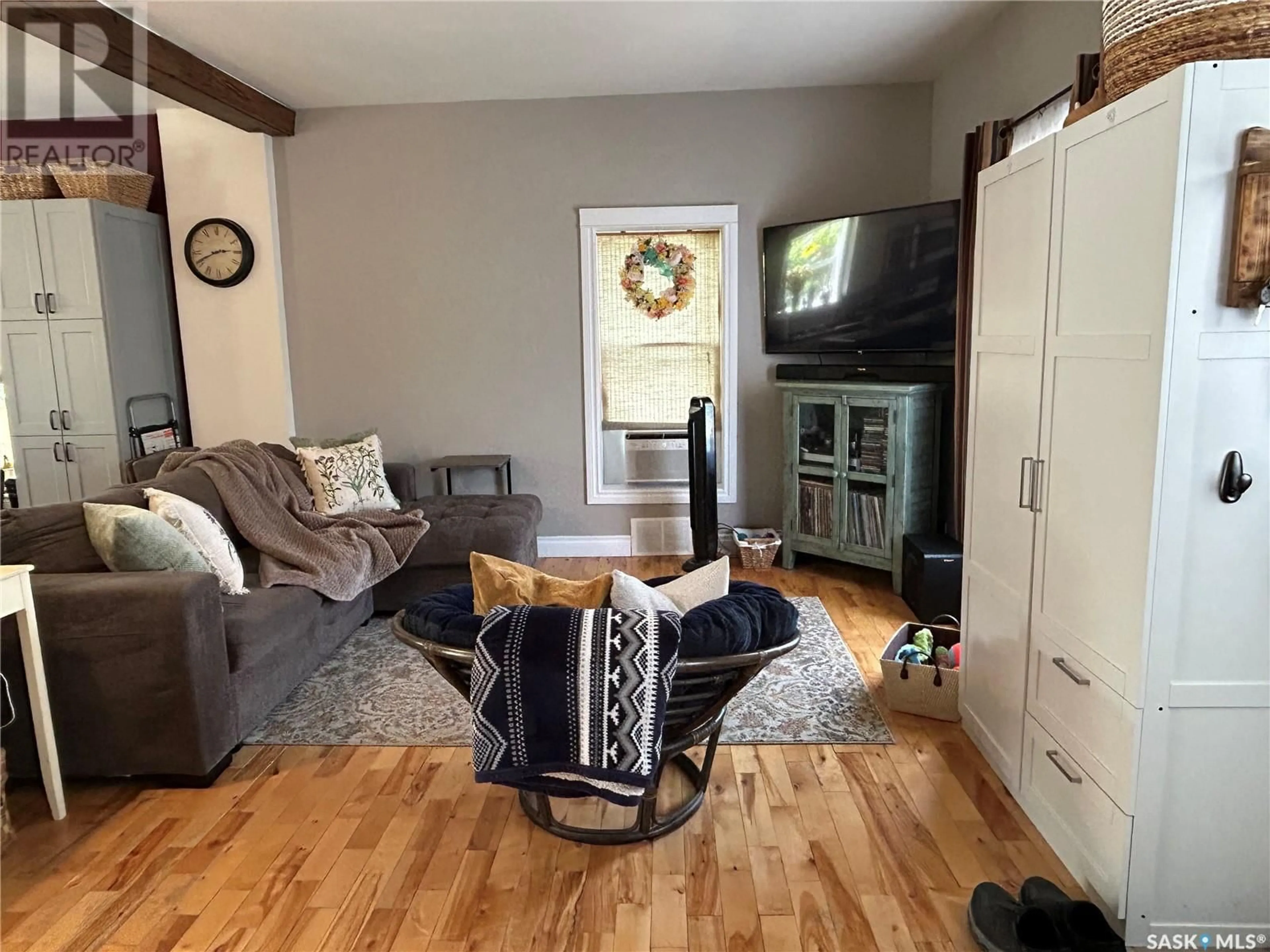 Living room with furniture, wood/laminate floor for 1018 3RD STREET, Estevan Saskatchewan S4A0R5
