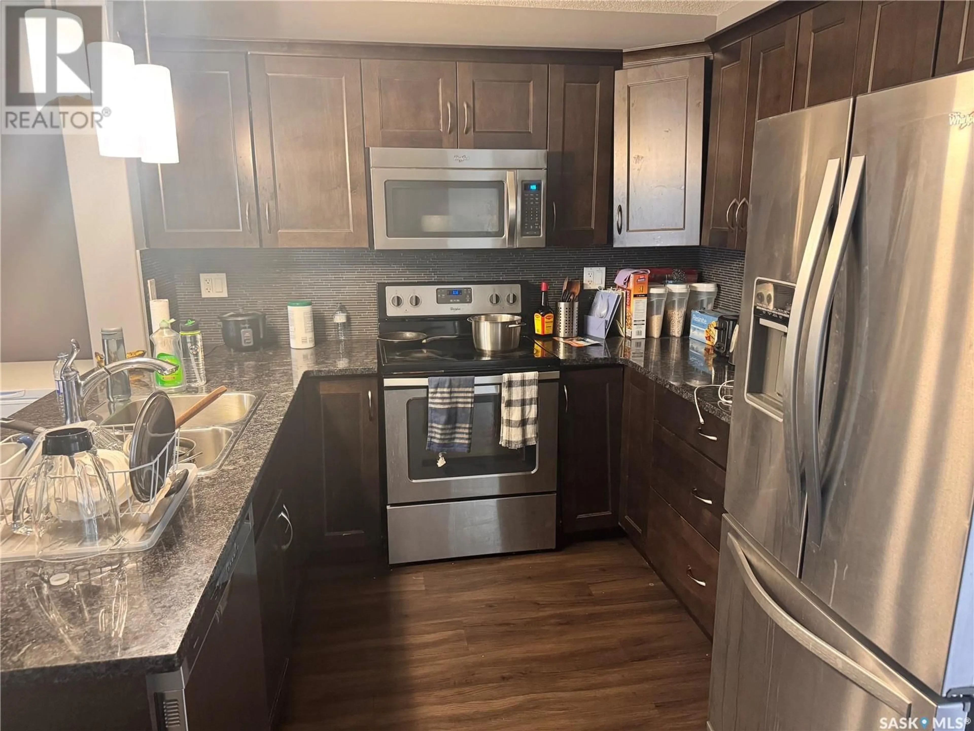 Open concept kitchen, wood/laminate floor for 210 - 209 RAJPUT WAY, Saskatoon Saskatchewan S7W0V7