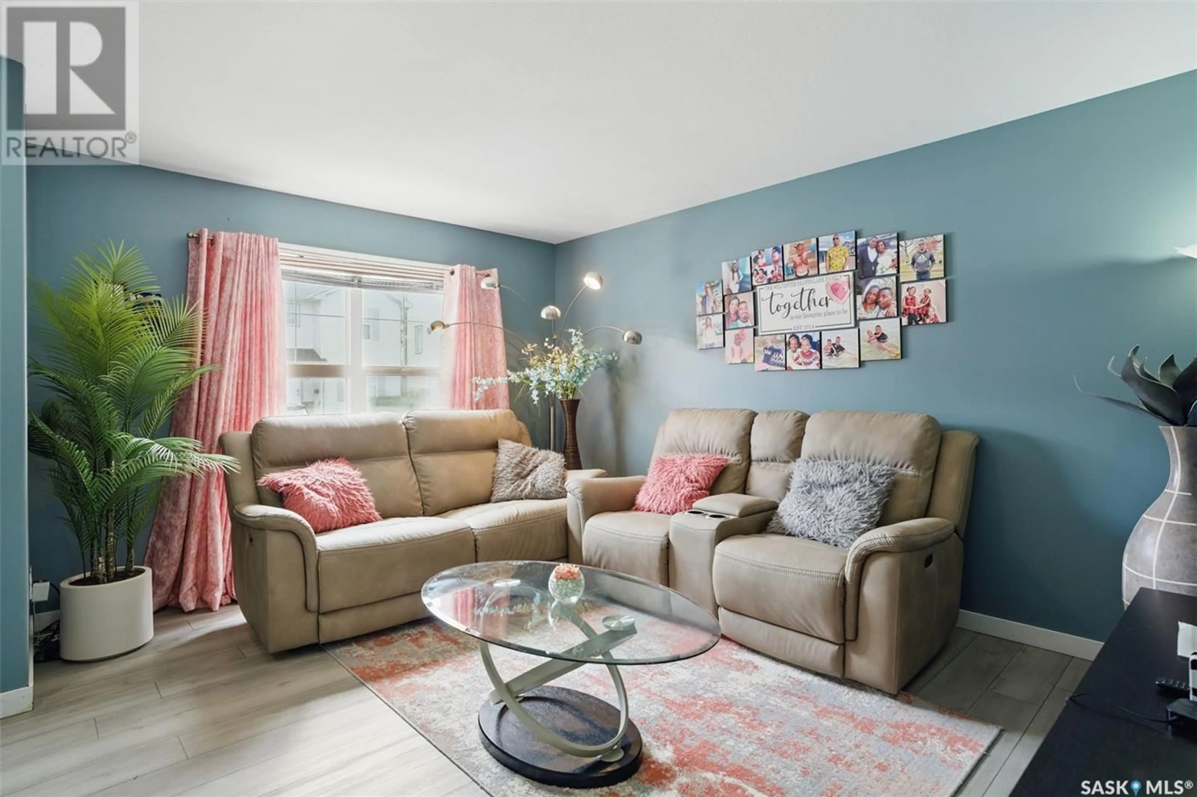 Living room with furniture, wood/laminate floor for 19 135 PAWLYCHENKO LANE, Saskatoon Saskatchewan S7V1J8