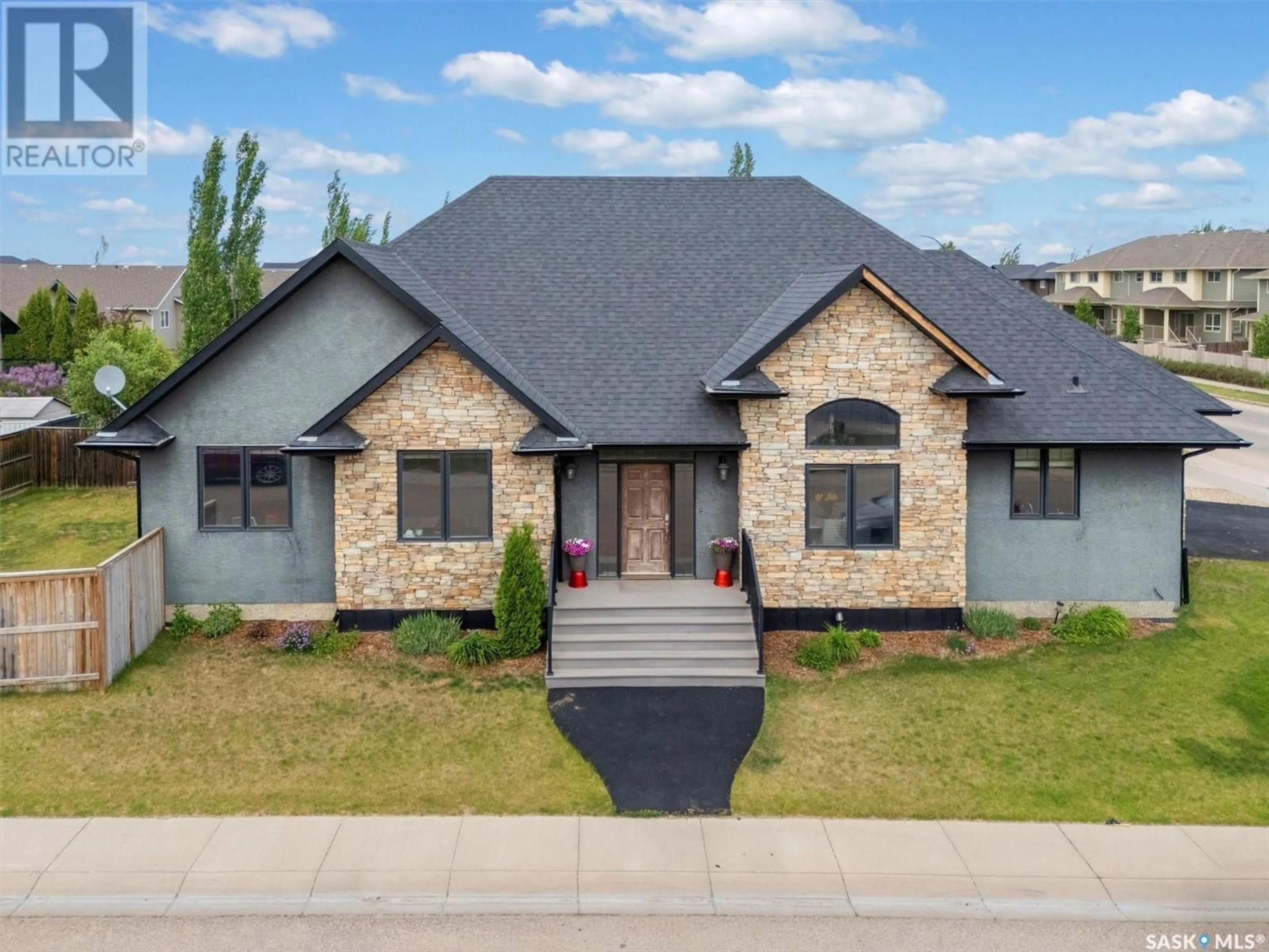 Home with brick exterior material, street for 1103 STENSRUD ROAD, Saskatoon Saskatchewan S7W0C9