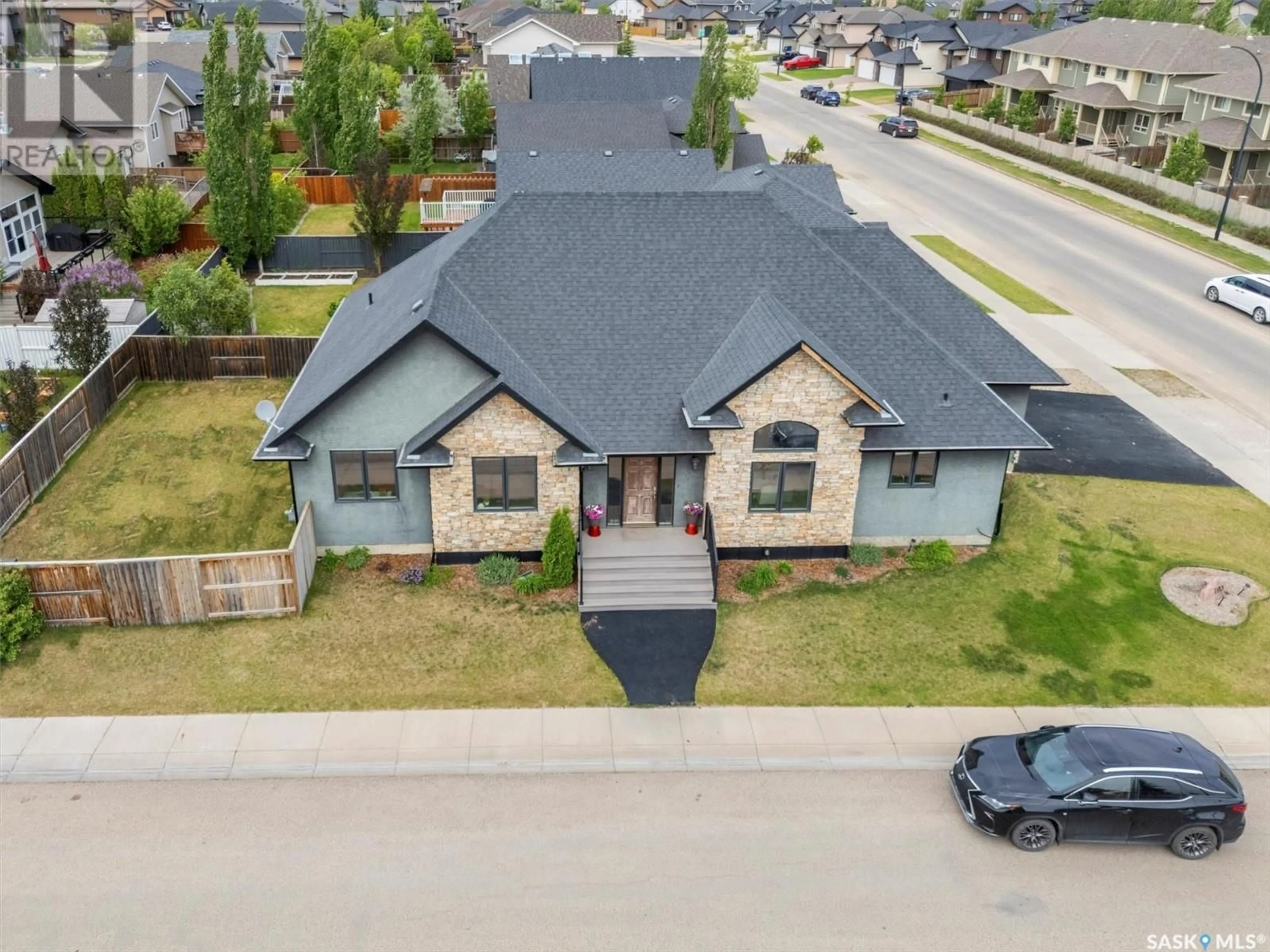 A pic from outside/outdoor area/front of a property/back of a property/a pic from drone, street for 1103 STENSRUD ROAD, Saskatoon Saskatchewan S7W0C9