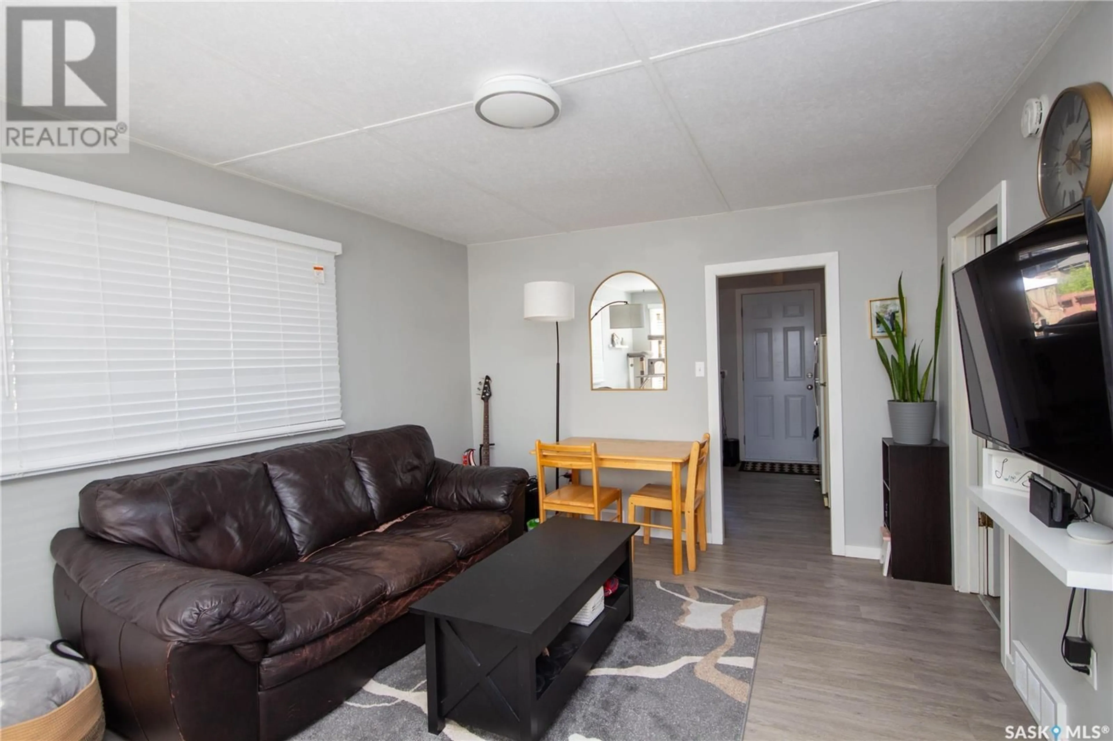 Living room with furniture, wood/laminate floor for 632 102ND STREET, North Battleford Saskatchewan S9A1E1