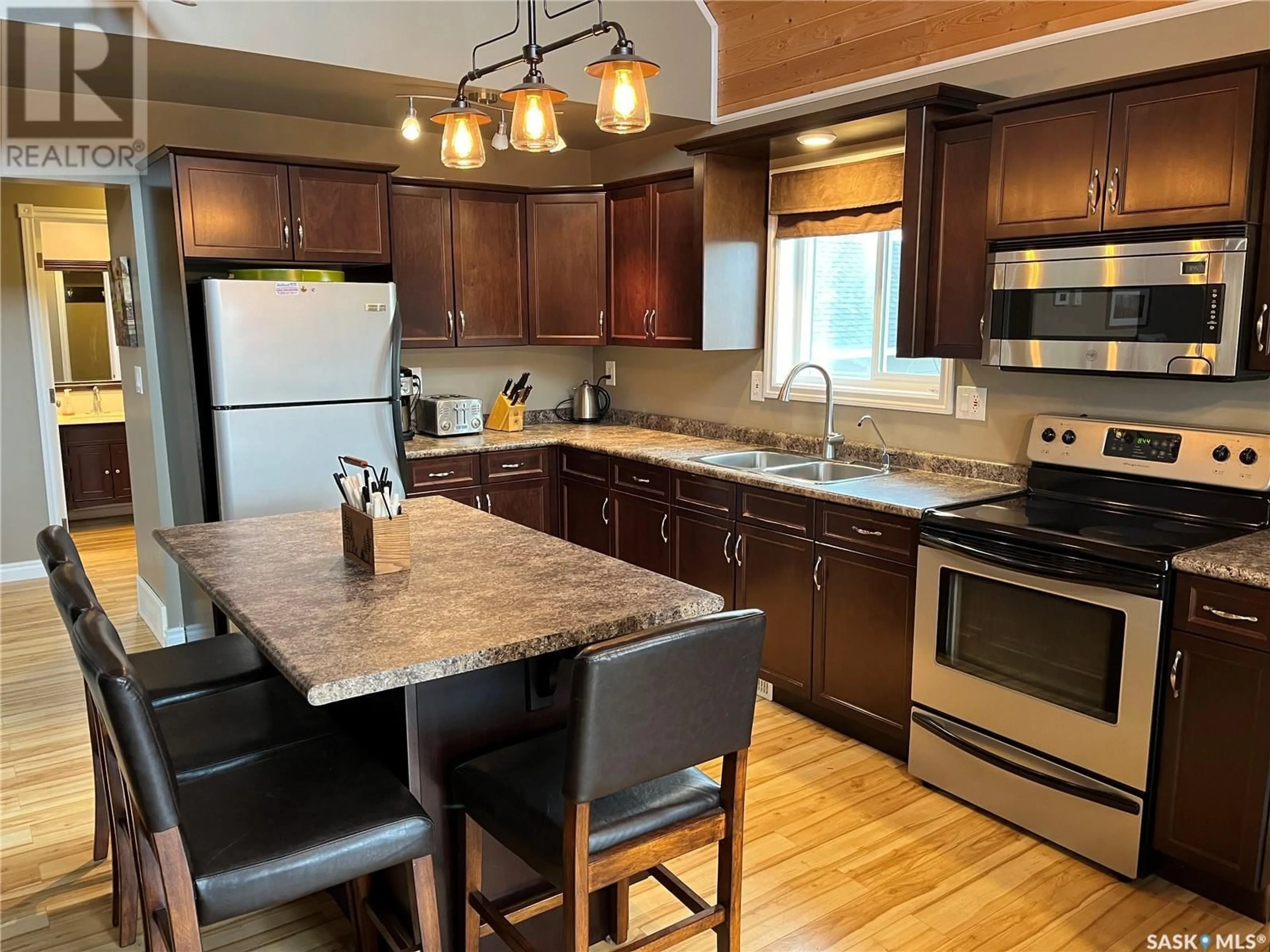 Open concept kitchen, wood/laminate floor for 104 SUNRIDGE ROAD, Pebble Baye Saskatchewan S0J2G0