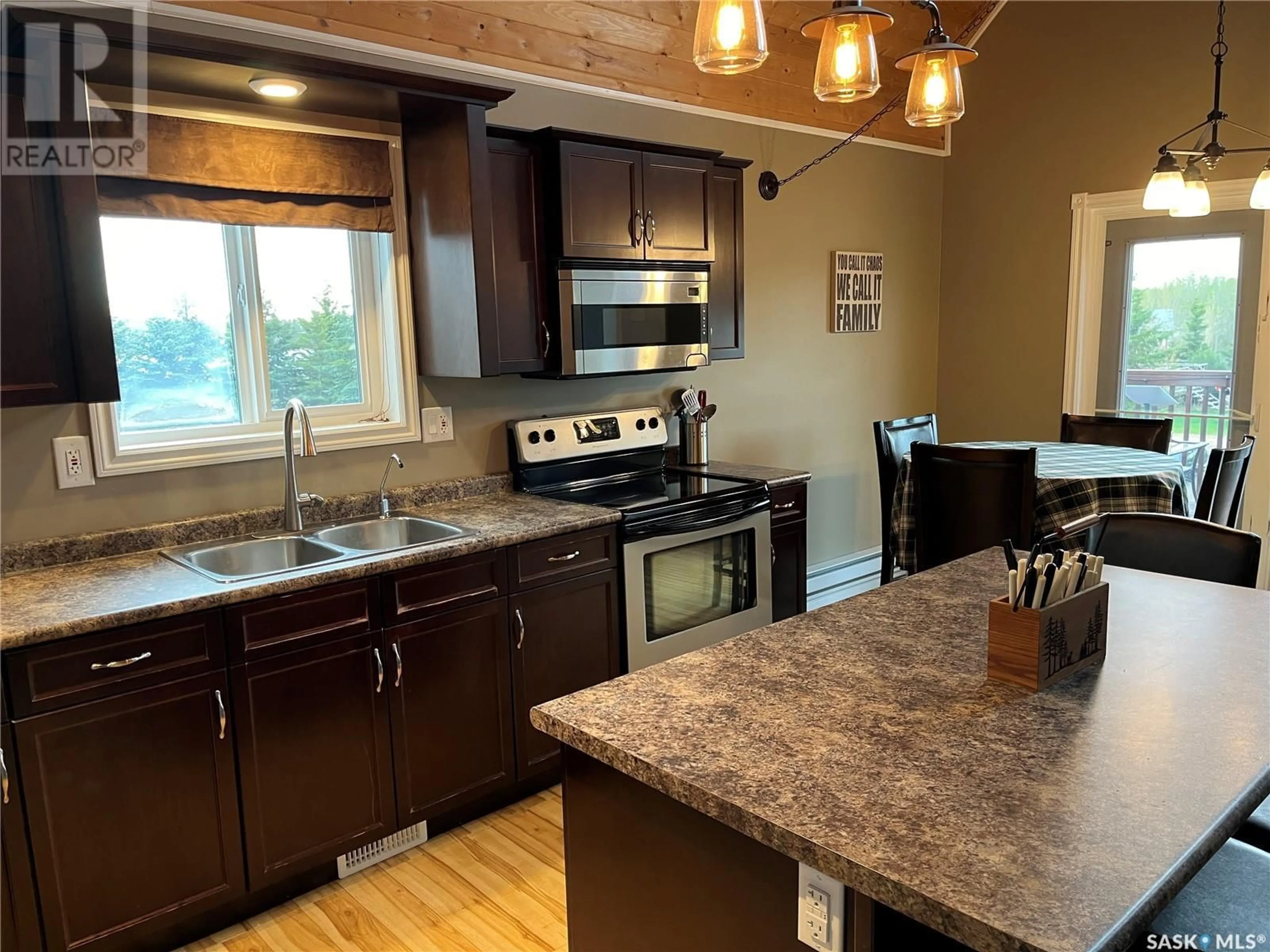 Open concept kitchen, wood/laminate floor for 104 SUNRIDGE ROAD, Pebble Baye Saskatchewan S0J2G0