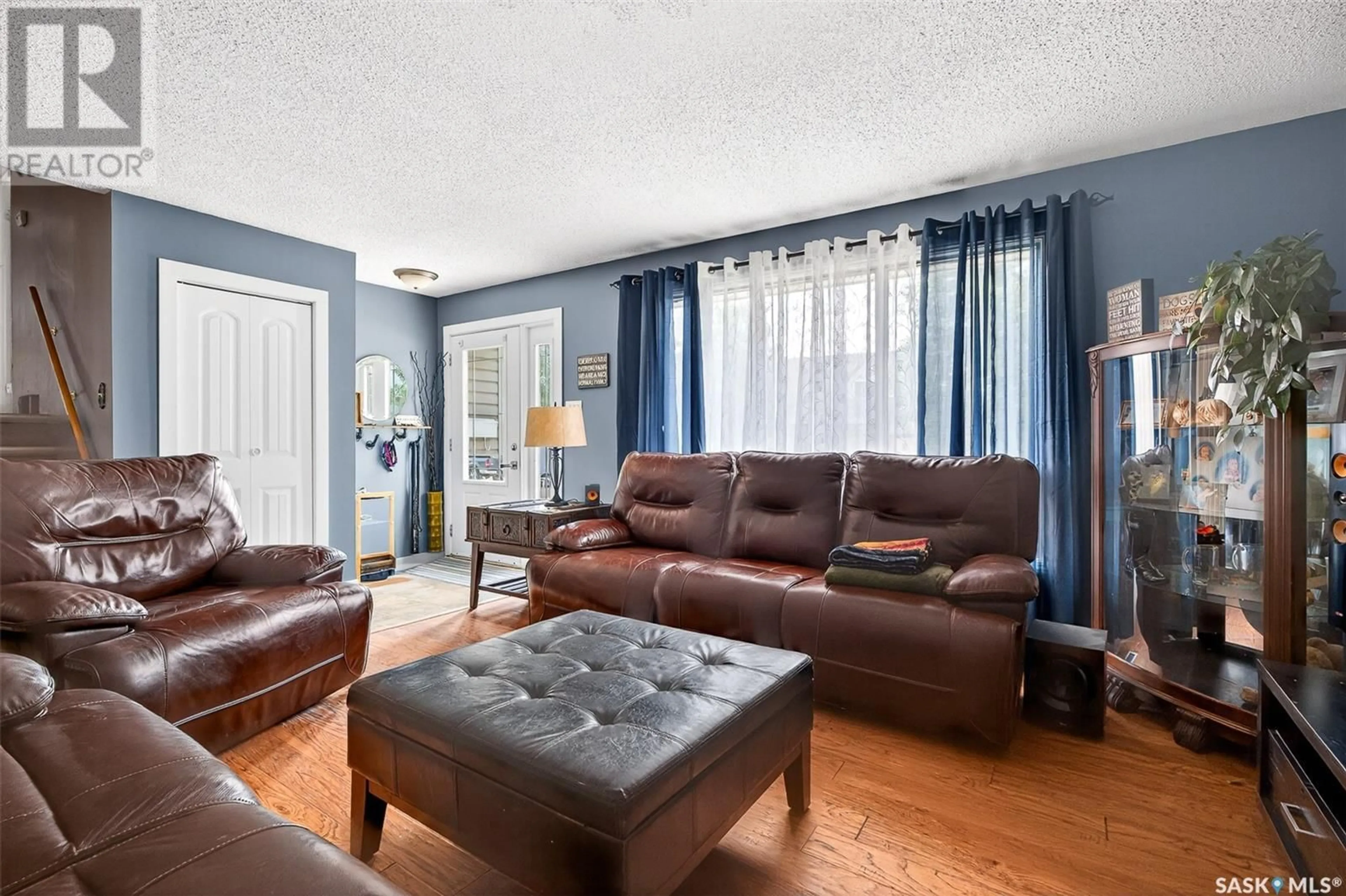 Living room with furniture, wood/laminate floor for 24 BLUEBELL CRESCENT, Moose Jaw Saskatchewan S6J1A2