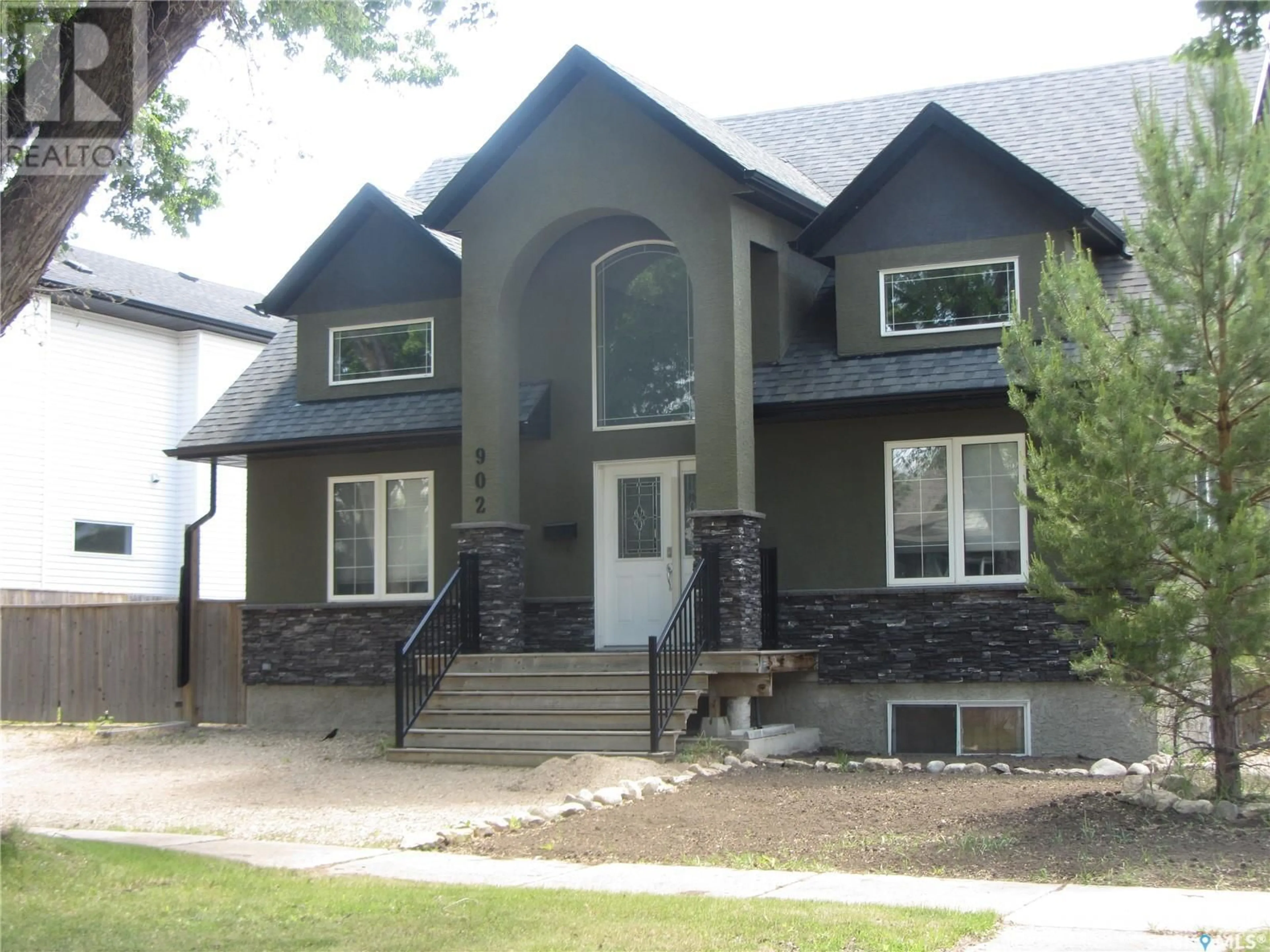 Home with vinyl exterior material, street for 902 6TH STREET, Saskatoon Saskatchewan S7H1C9