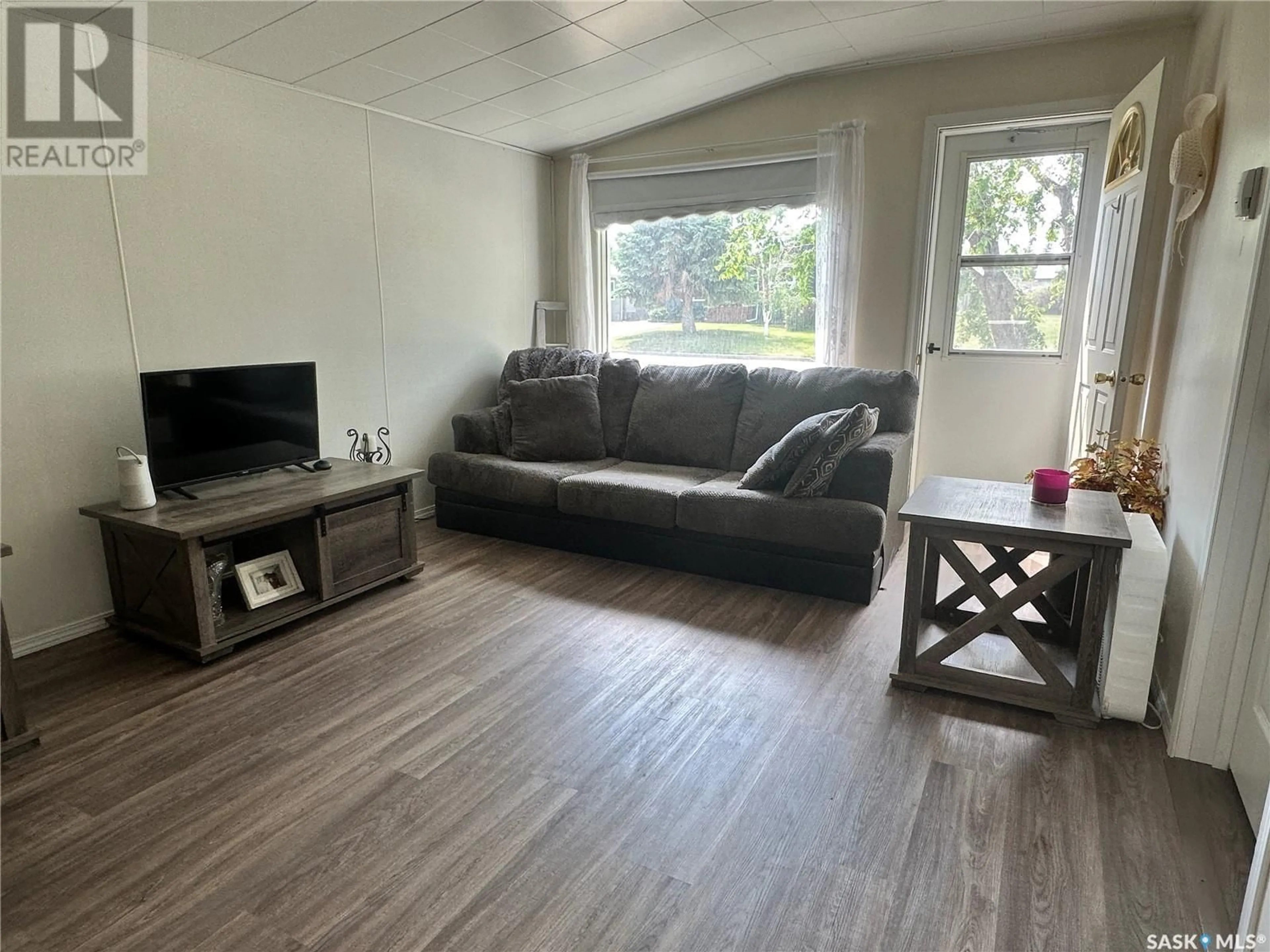Living room with furniture, wood/laminate floor for 510 7TH STREET, Wynyard Saskatchewan S0A4T0