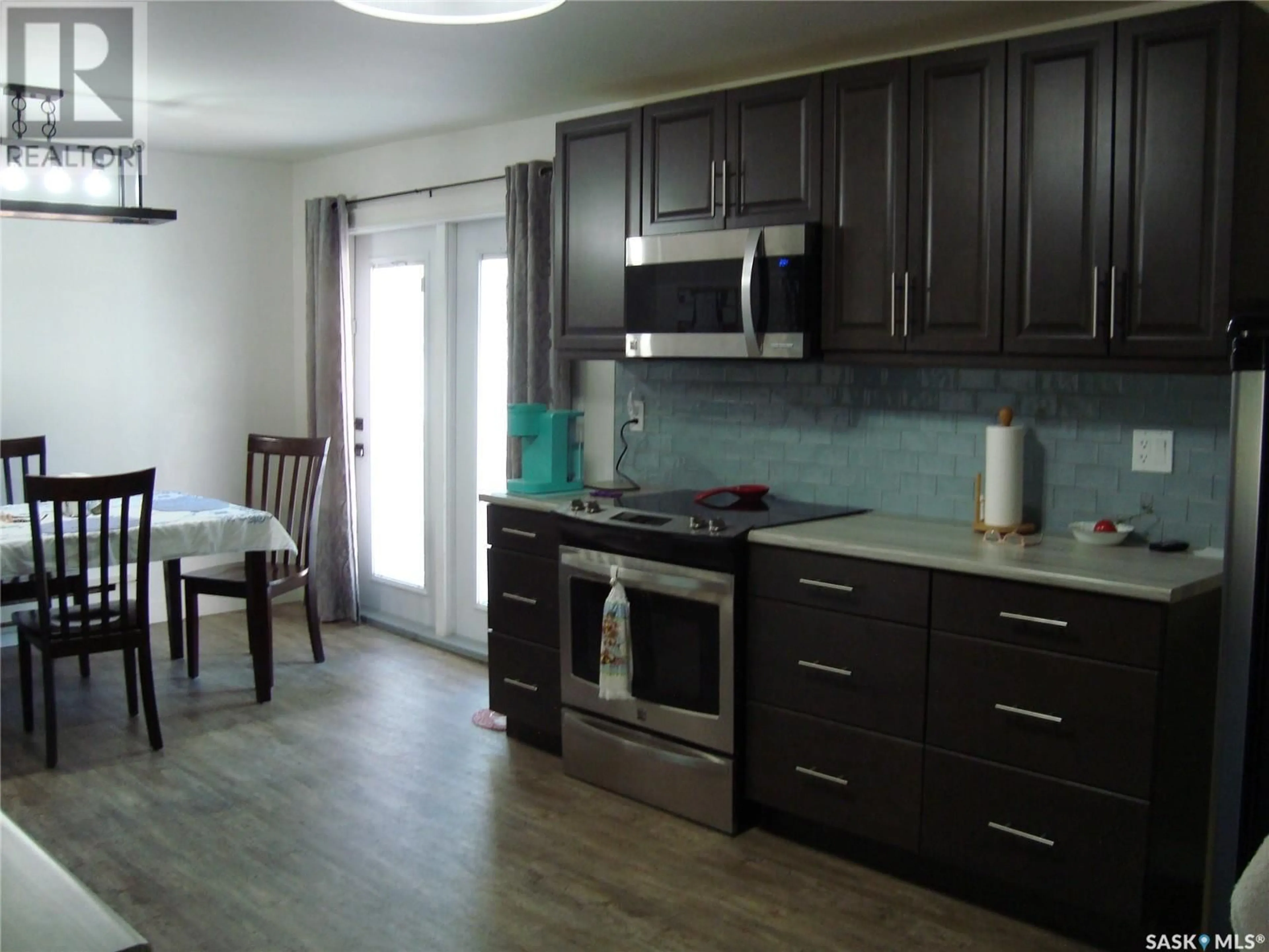 Open concept kitchen, wood/laminate floor for 403 CENTRE STREET, Cabri Saskatchewan S0N0J0