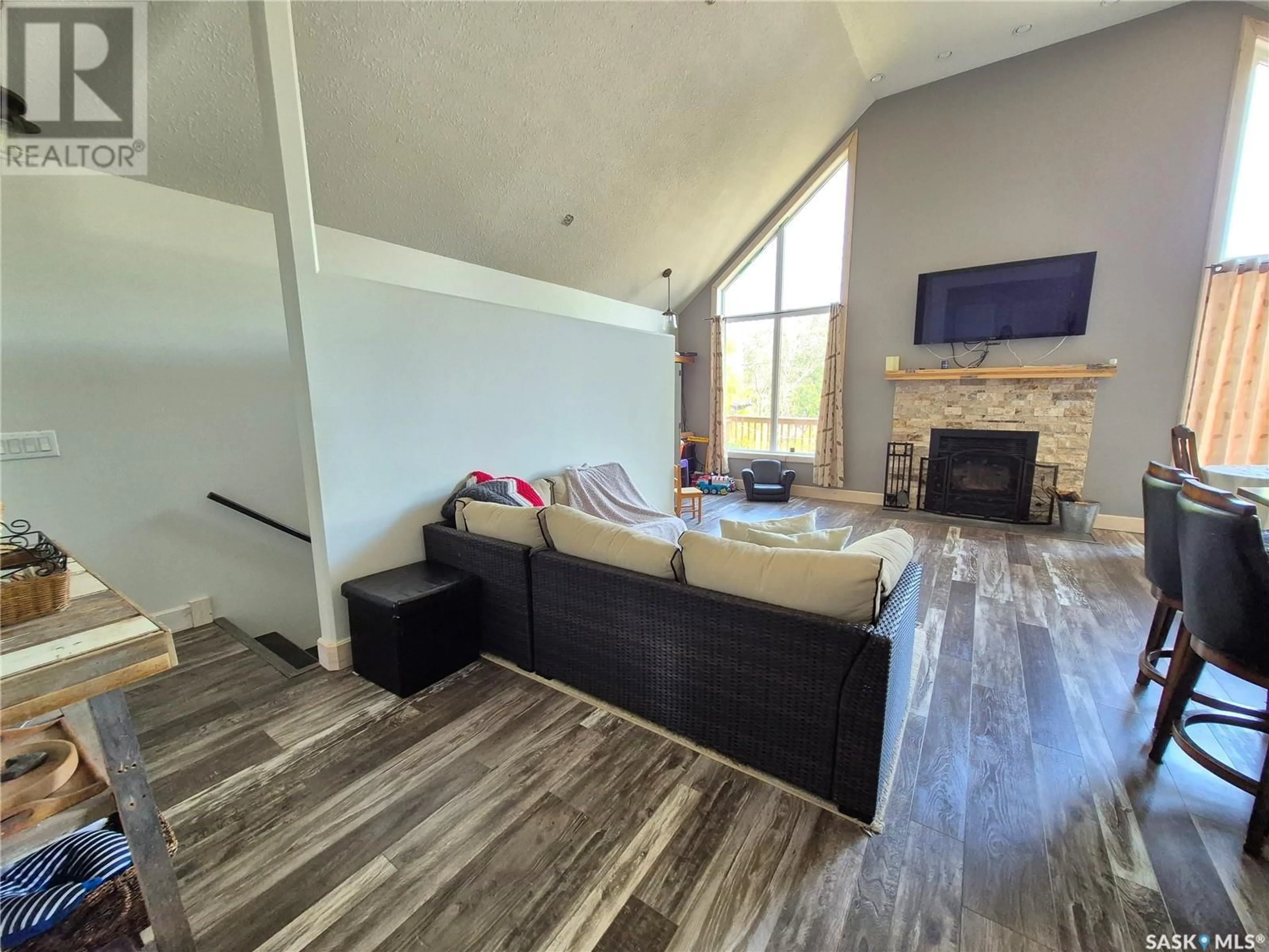 Living room with furniture, wood/laminate floor for 302 MARTIN STREET, Pangman Saskatchewan S0C2C0