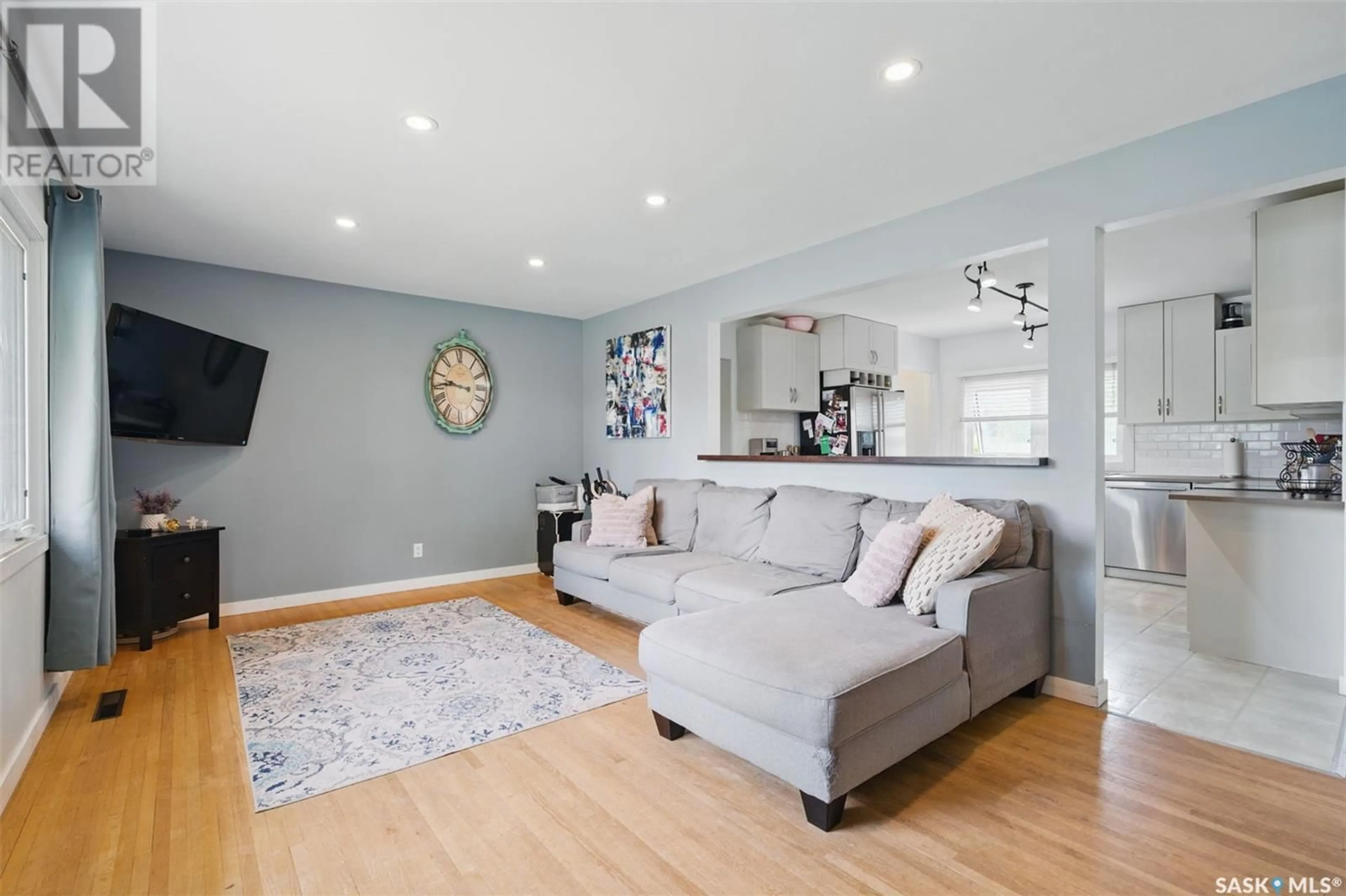 Living room with furniture, wood/laminate floor for 1604 LANDA STREET, Saskatoon Saskatchewan S7J0P6