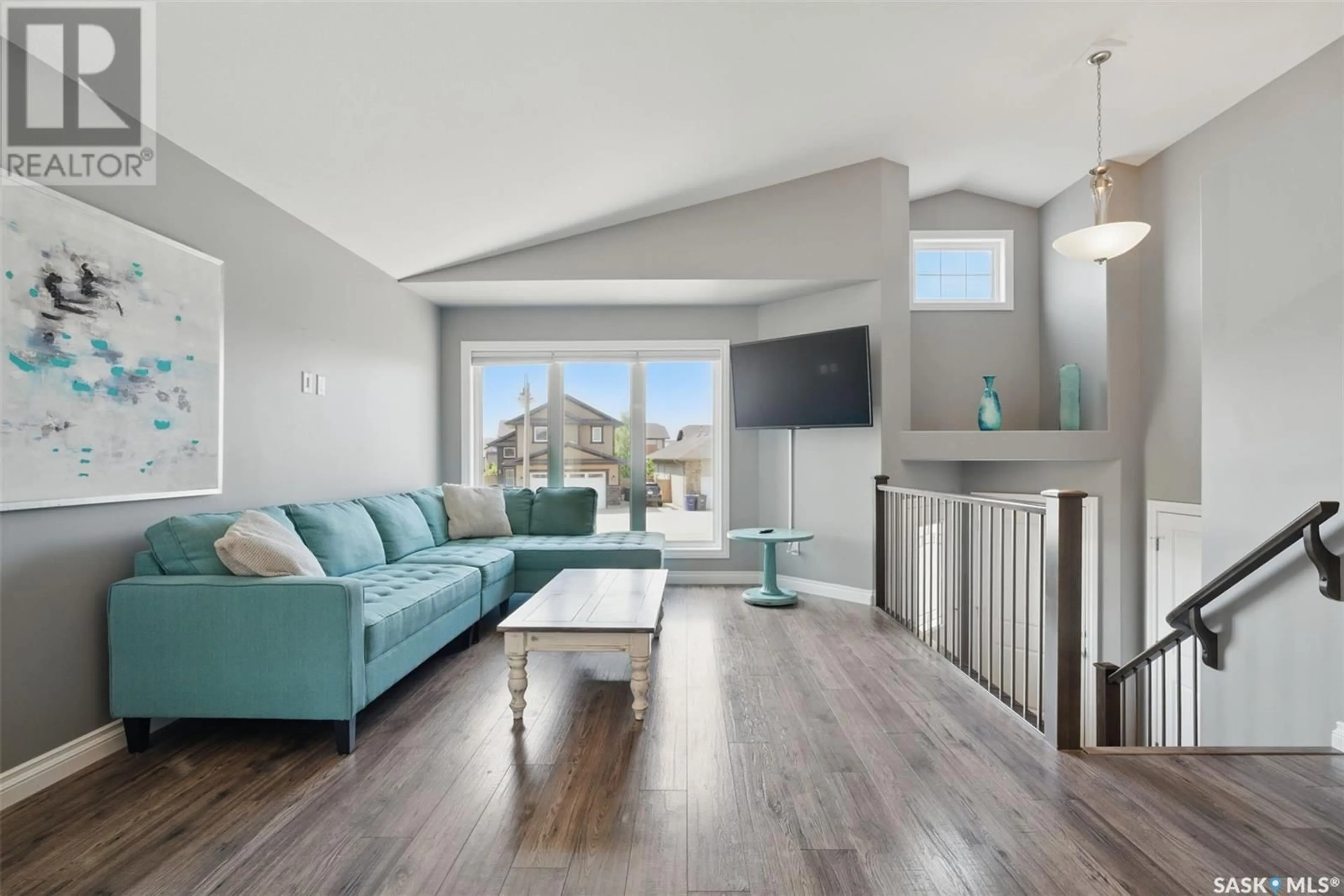 Living room with furniture, wood/laminate floor for 607 PRINGLE BEND, Saskatoon Saskatchewan S7T0S7