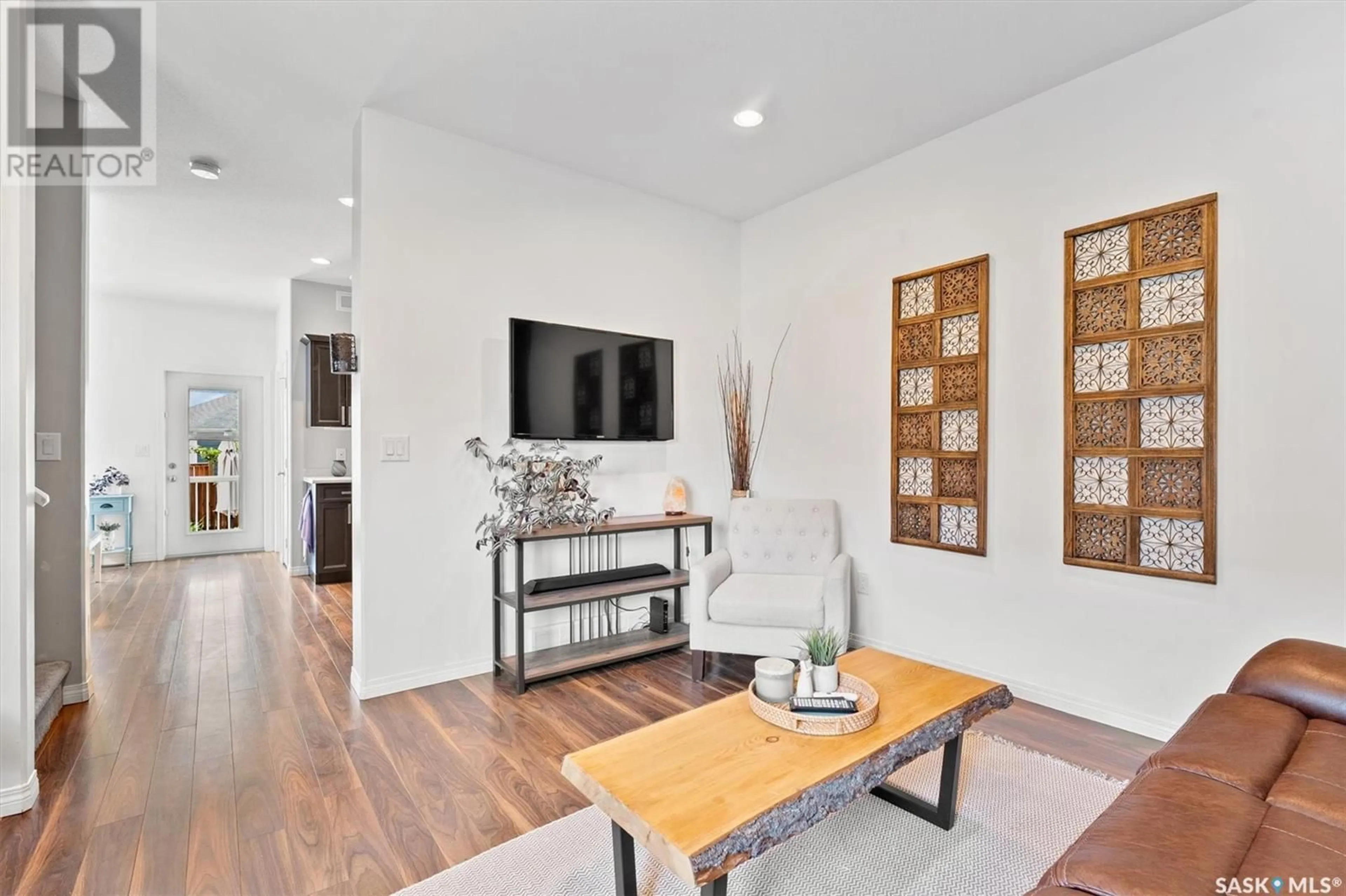 Living room with furniture, wood/laminate floor for 715 GOWAN ROAD, Warman Saskatchewan S0K4S2