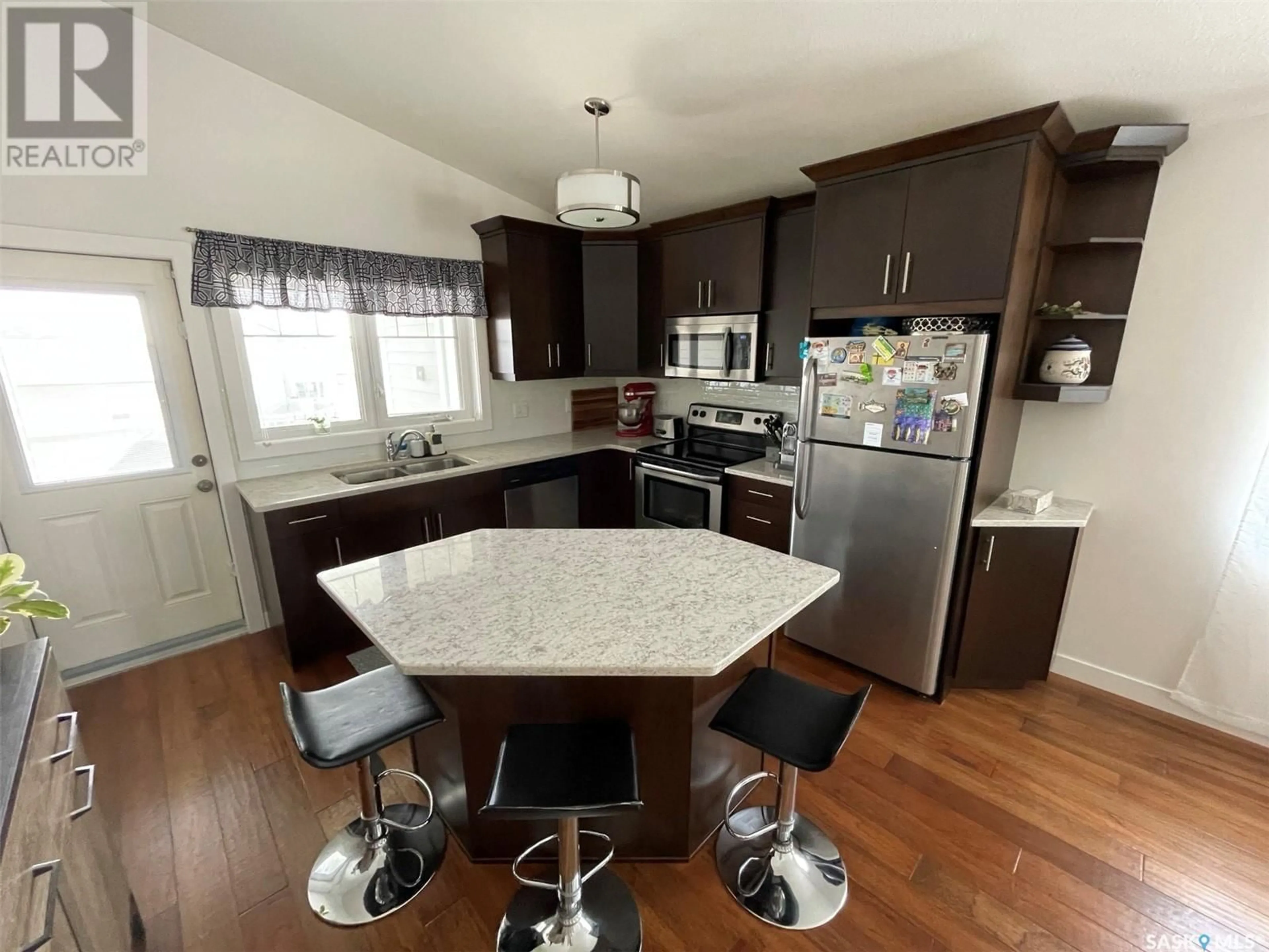 Open concept kitchen, wood/laminate floor for 4267 GREEN APPLE DRIVE, Regina Saskatchewan S4V1M6