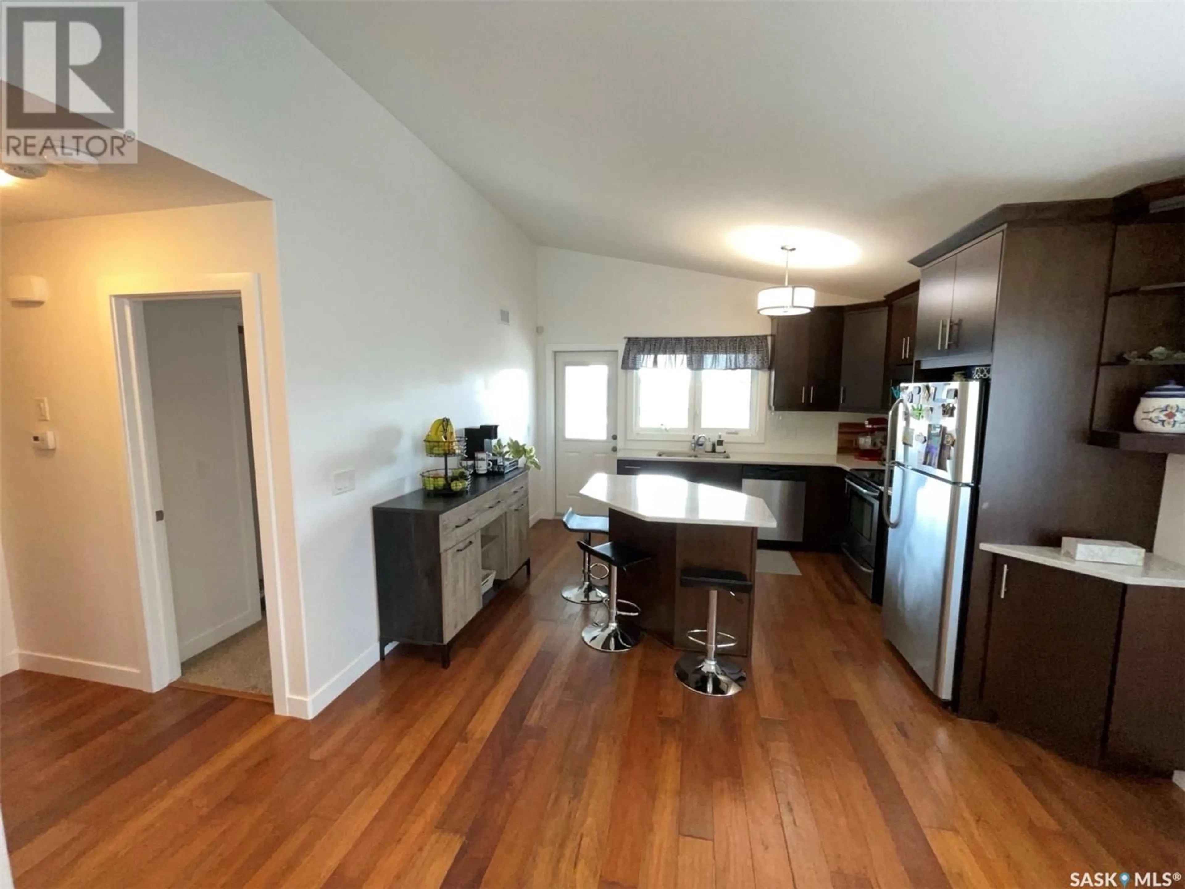 Open concept kitchen, wood/laminate floor for 4267 GREEN APPLE DRIVE, Regina Saskatchewan S4V1M6