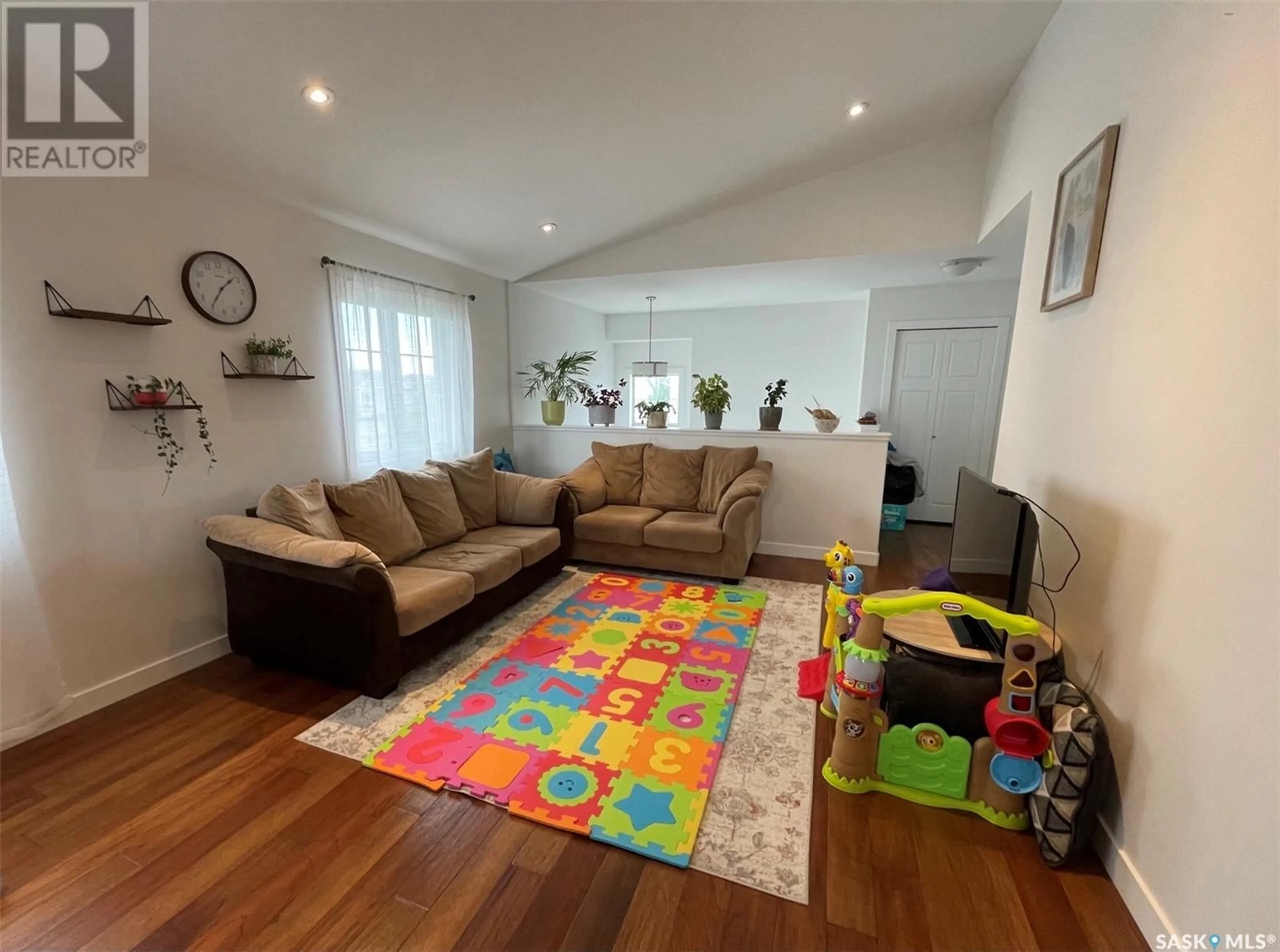 Living room with furniture, wood/laminate floor for 4267 GREEN APPLE DRIVE, Regina Saskatchewan S4V1M6