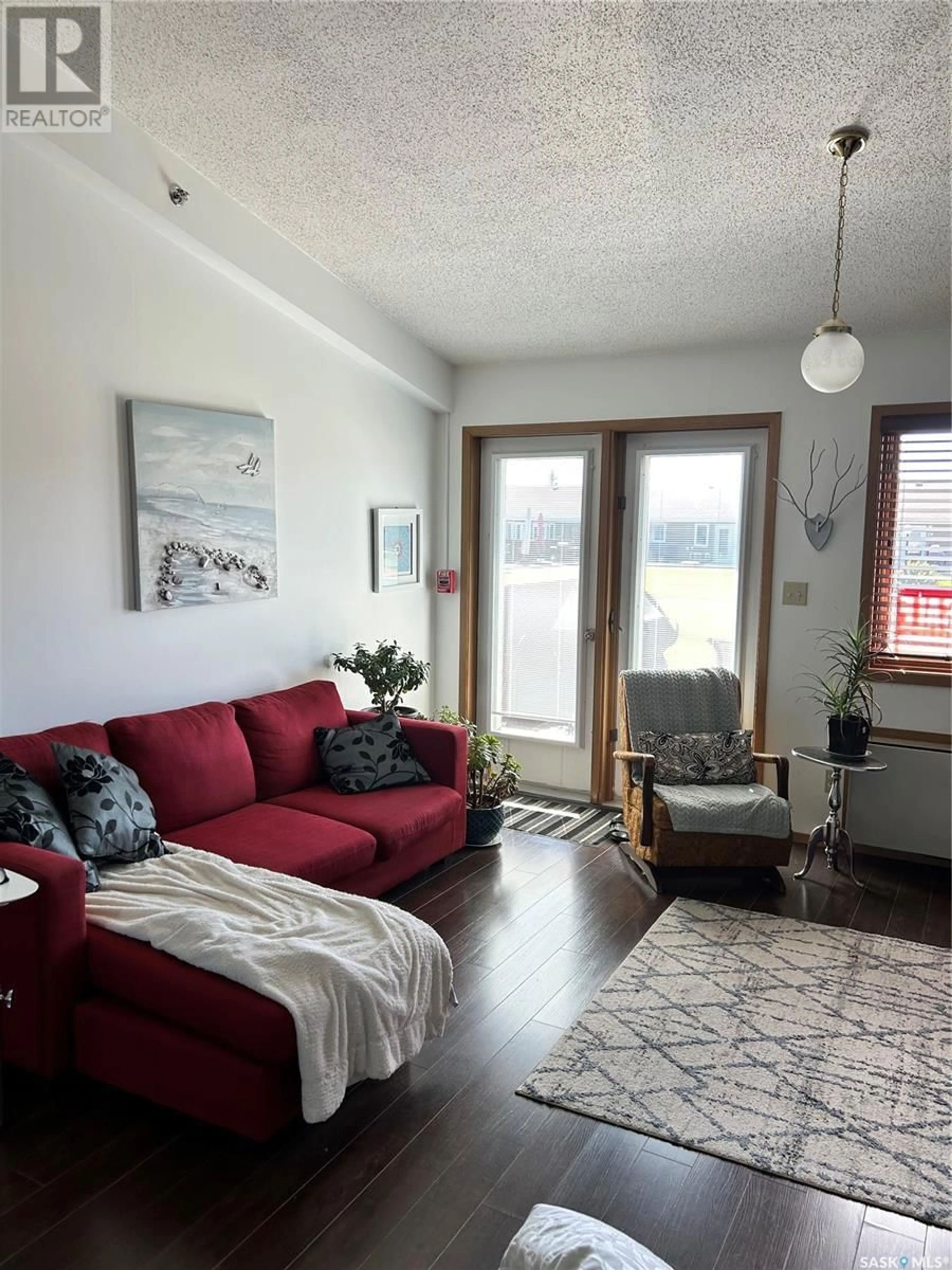 Living room with furniture, wood/laminate floor for 15 1250 AARO AVENUE, Elbow Saskatchewan S0H1J0
