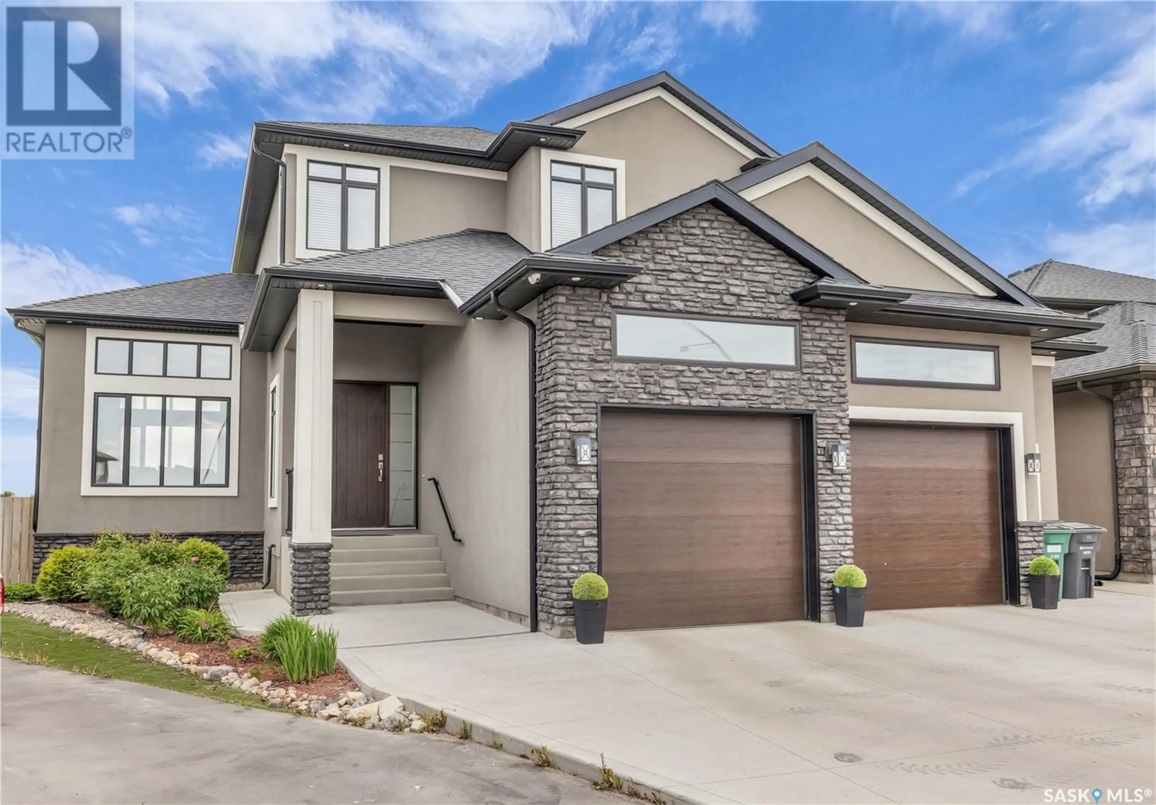 Home with brick exterior material, street for 516 BALTZAN BAY, Saskatoon Saskatchewan S7W0S1