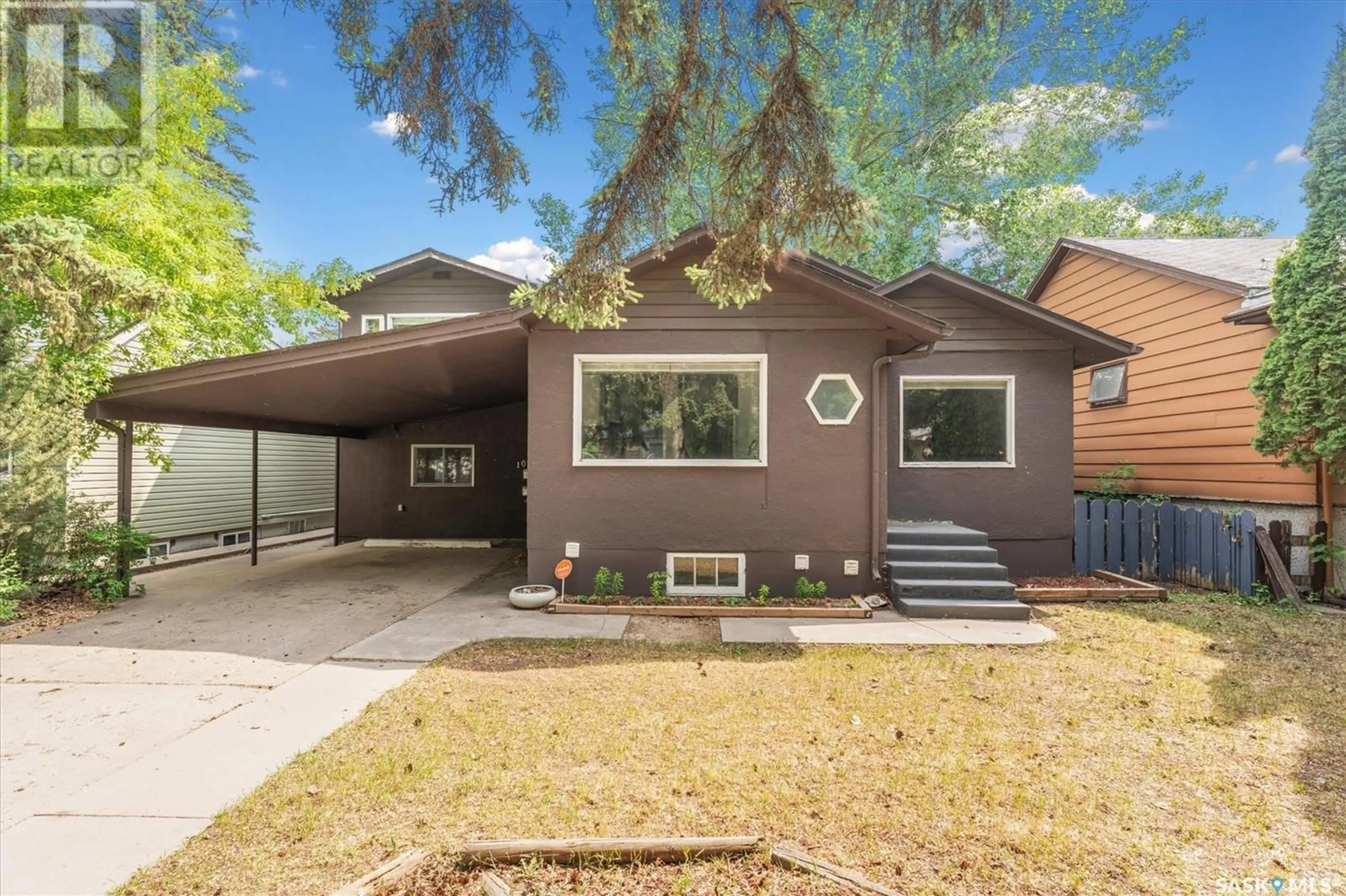 Home with vinyl exterior material, street for 1004 6TH STREET, Saskatoon Saskatchewan S7H1E2