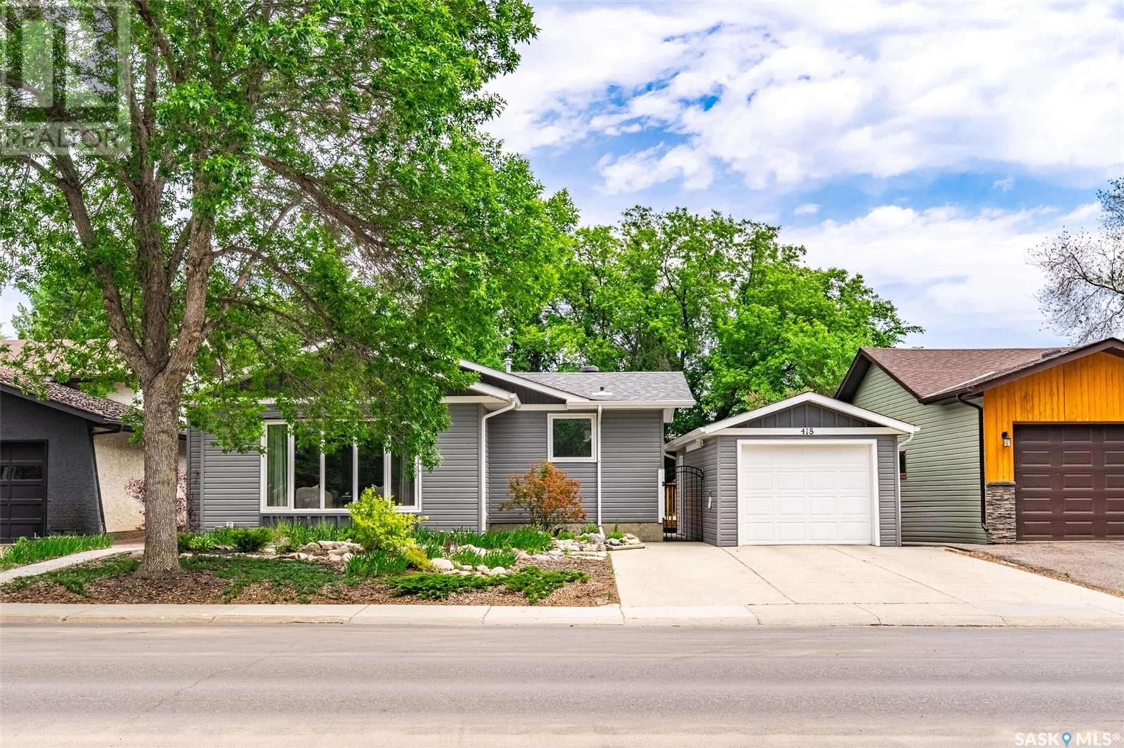 Home with vinyl exterior material, street for 418 SILVERWOOD ROAD, Saskatoon Saskatchewan S7K6N2