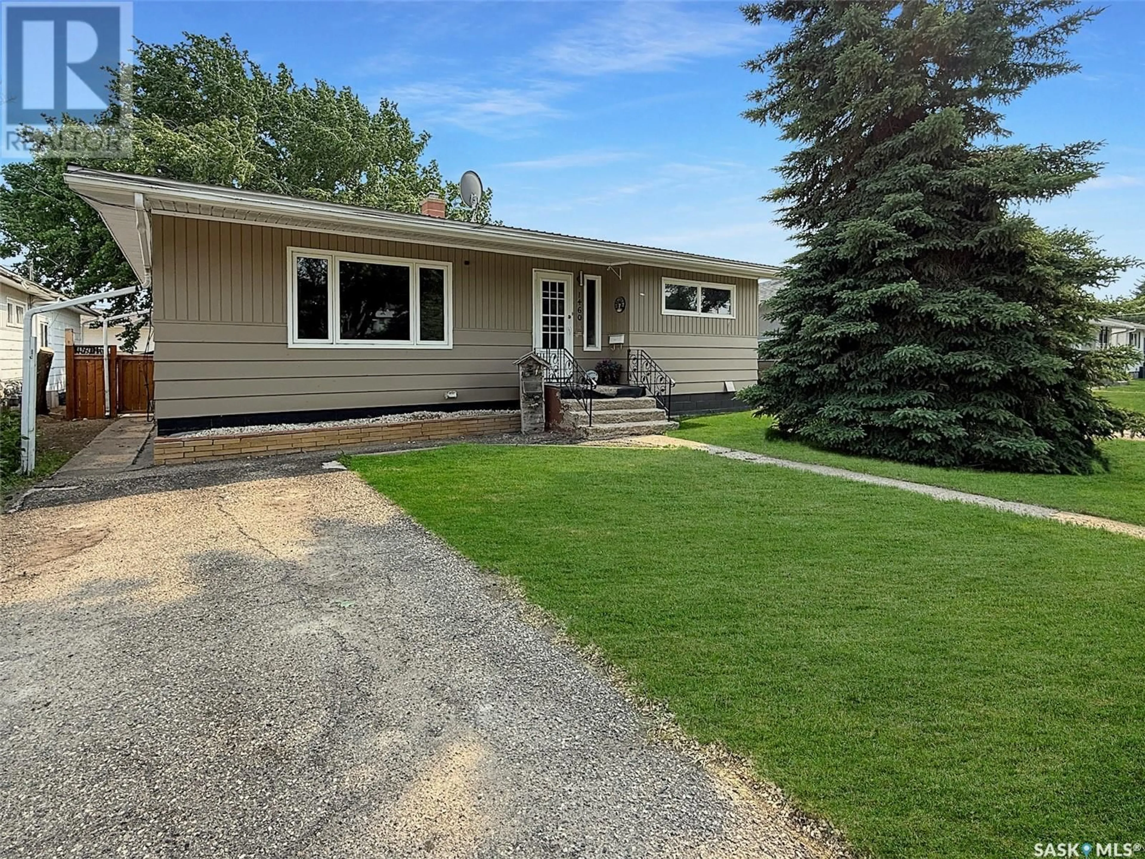 Home with vinyl exterior material, street for 1460 BELL STREET, Swift Current Saskatchewan S9H1S6