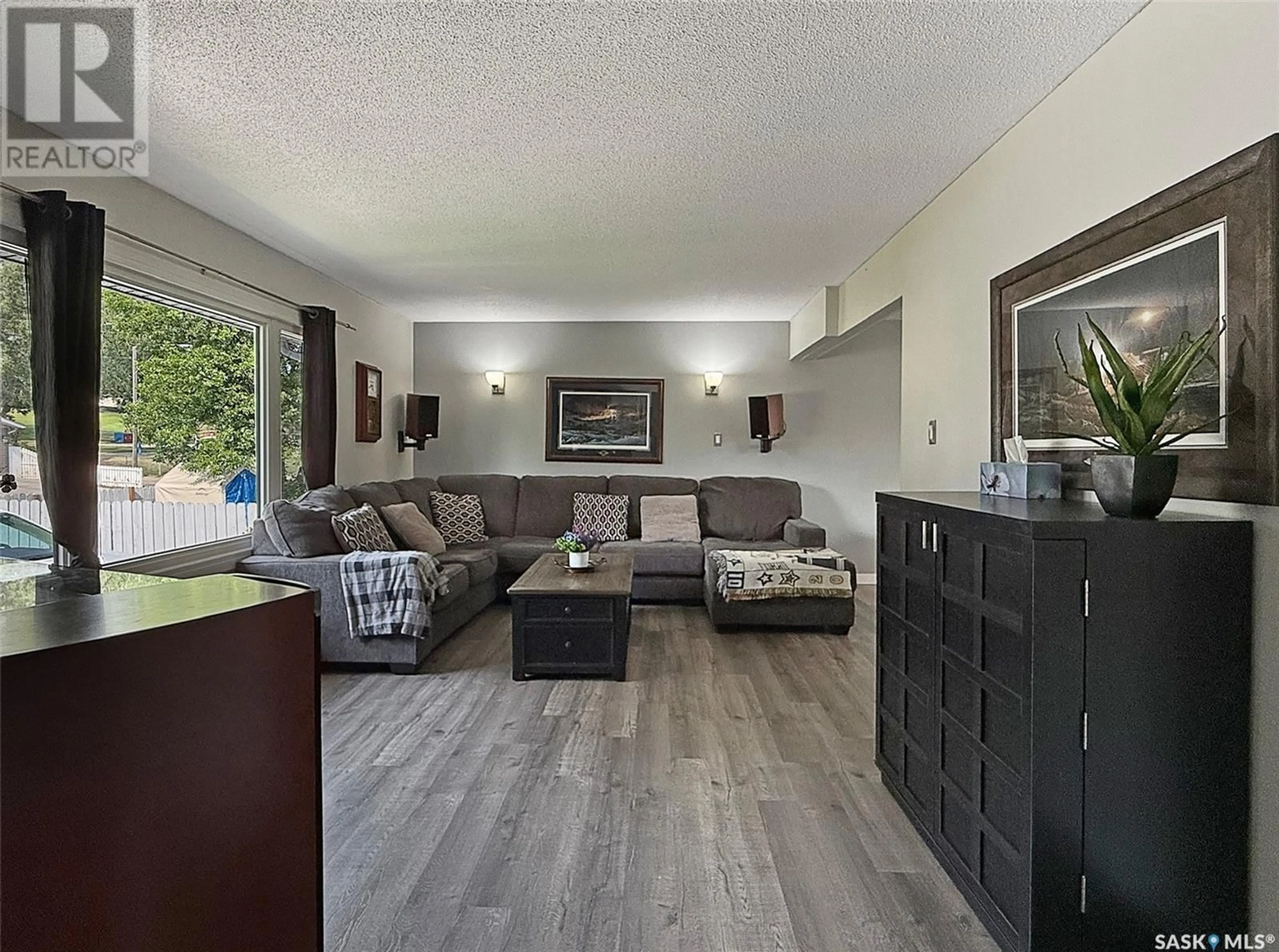 Living room with furniture, wood/laminate floor for 1460 BELL STREET, Swift Current Saskatchewan S9H1S6