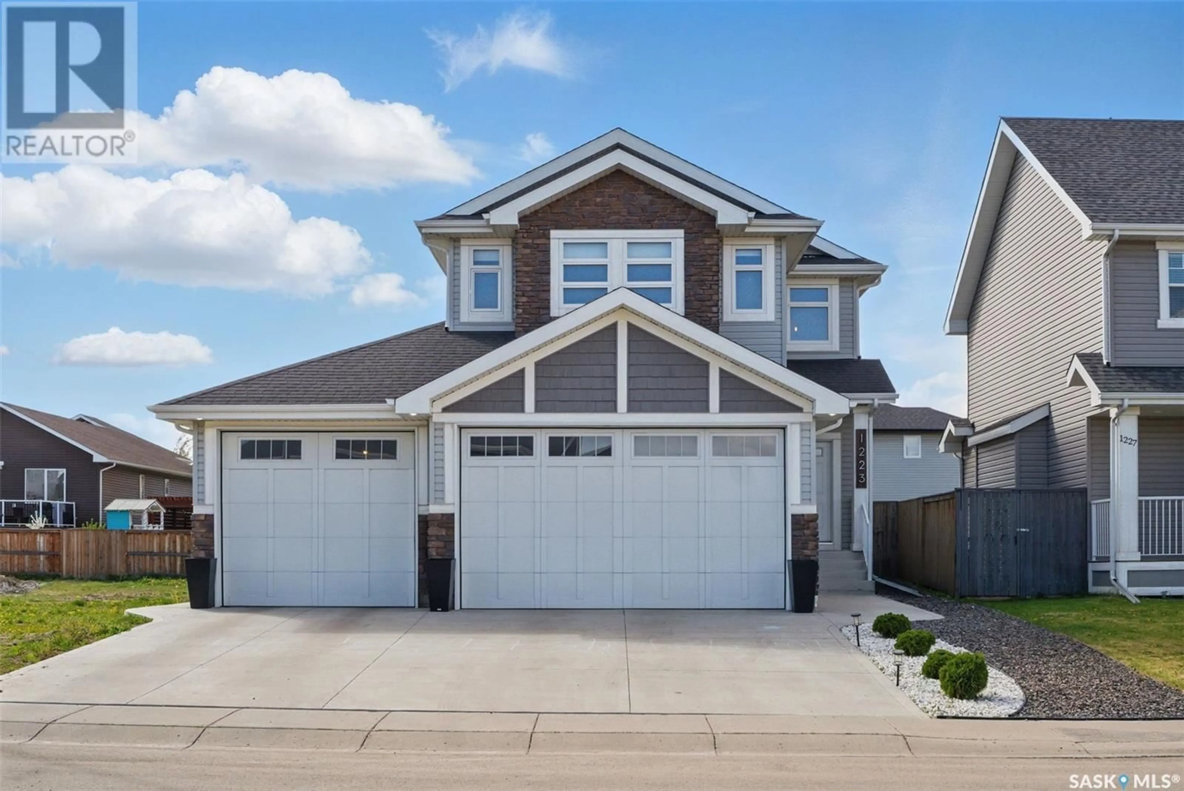 Home with vinyl exterior material, street for 1223 PRINGLE WAY, Saskatoon Saskatchewan S7T0V5