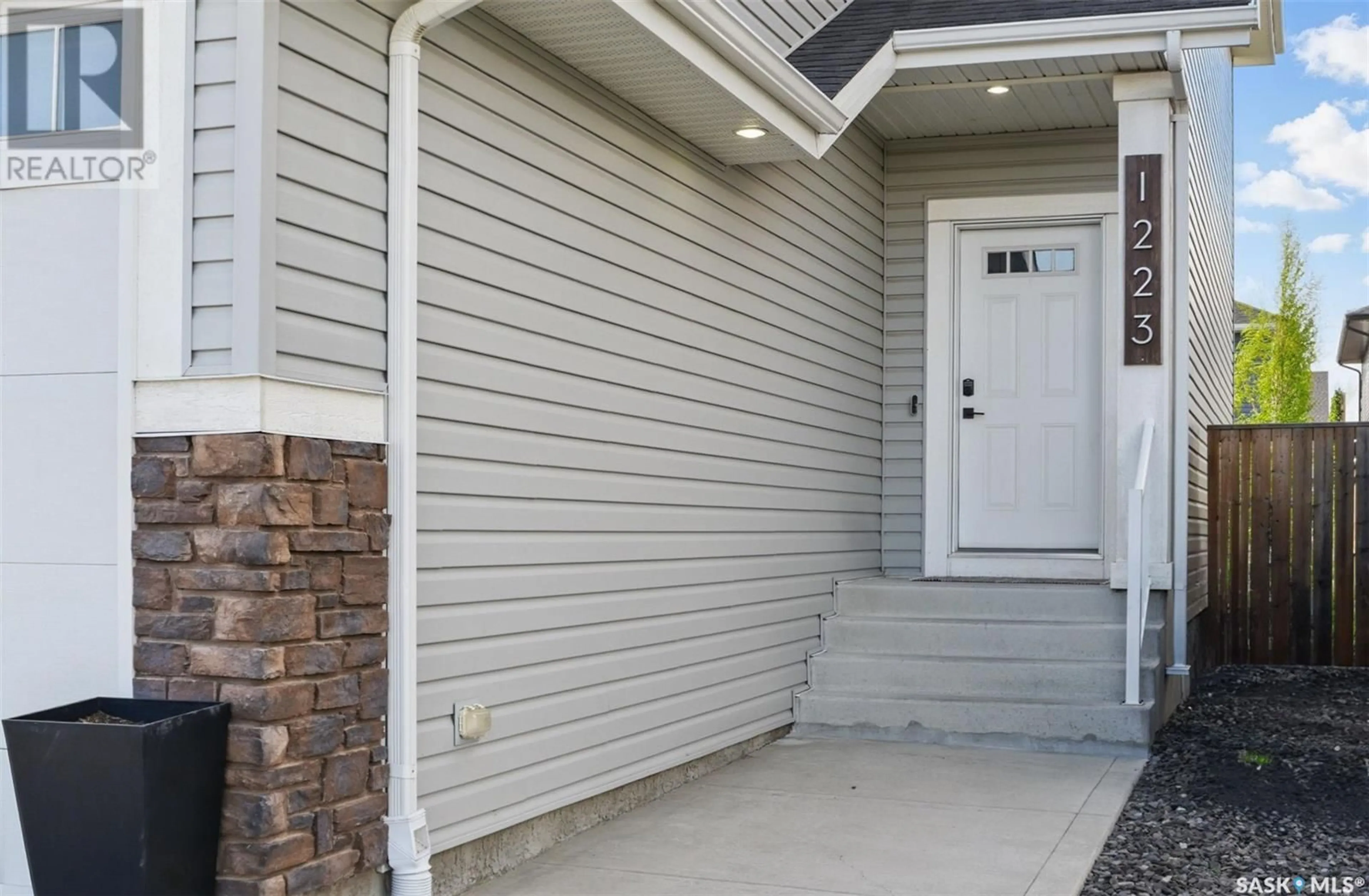 Home with vinyl exterior material, street for 1223 PRINGLE WAY, Saskatoon Saskatchewan S7T0V5
