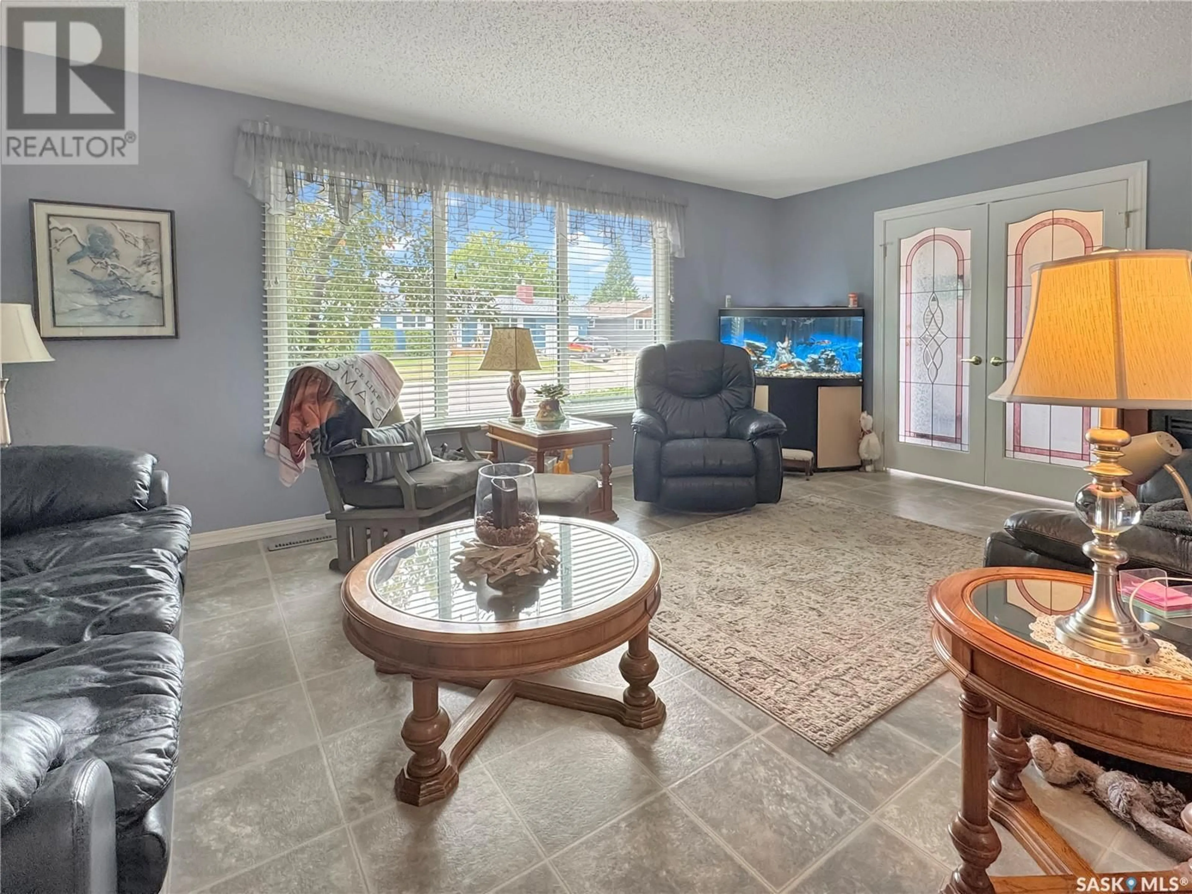 Living room with furniture, ceramic/tile floor for 2027 FOLEY DRIVE, North Battleford Saskatchewan S9A3H1