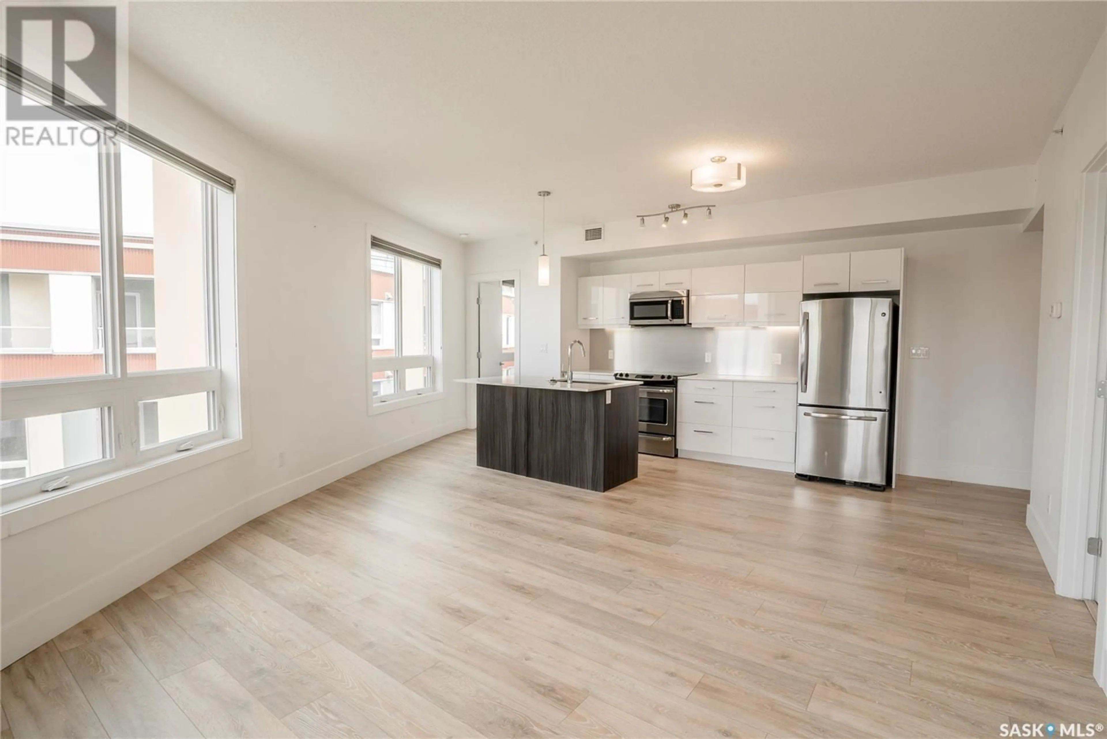 Open concept kitchen, wood/laminate floor for 409 - 403 B AVENUE S, Saskatoon Saskatchewan S7M5M8