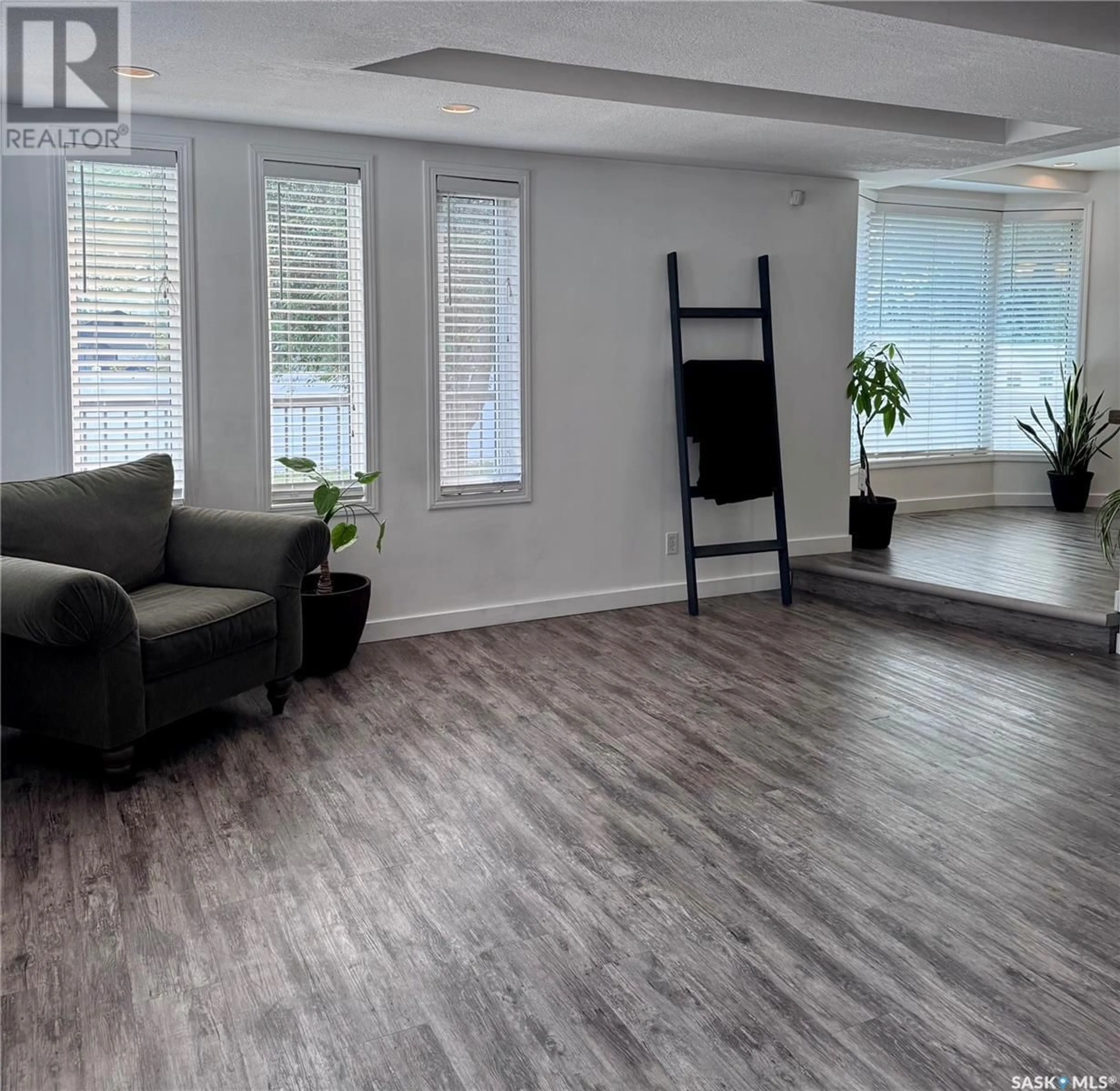 Living room with furniture, wood/laminate floor for 1159 CHAPLIN STREET E, Swift Current Saskatchewan S9H1J9