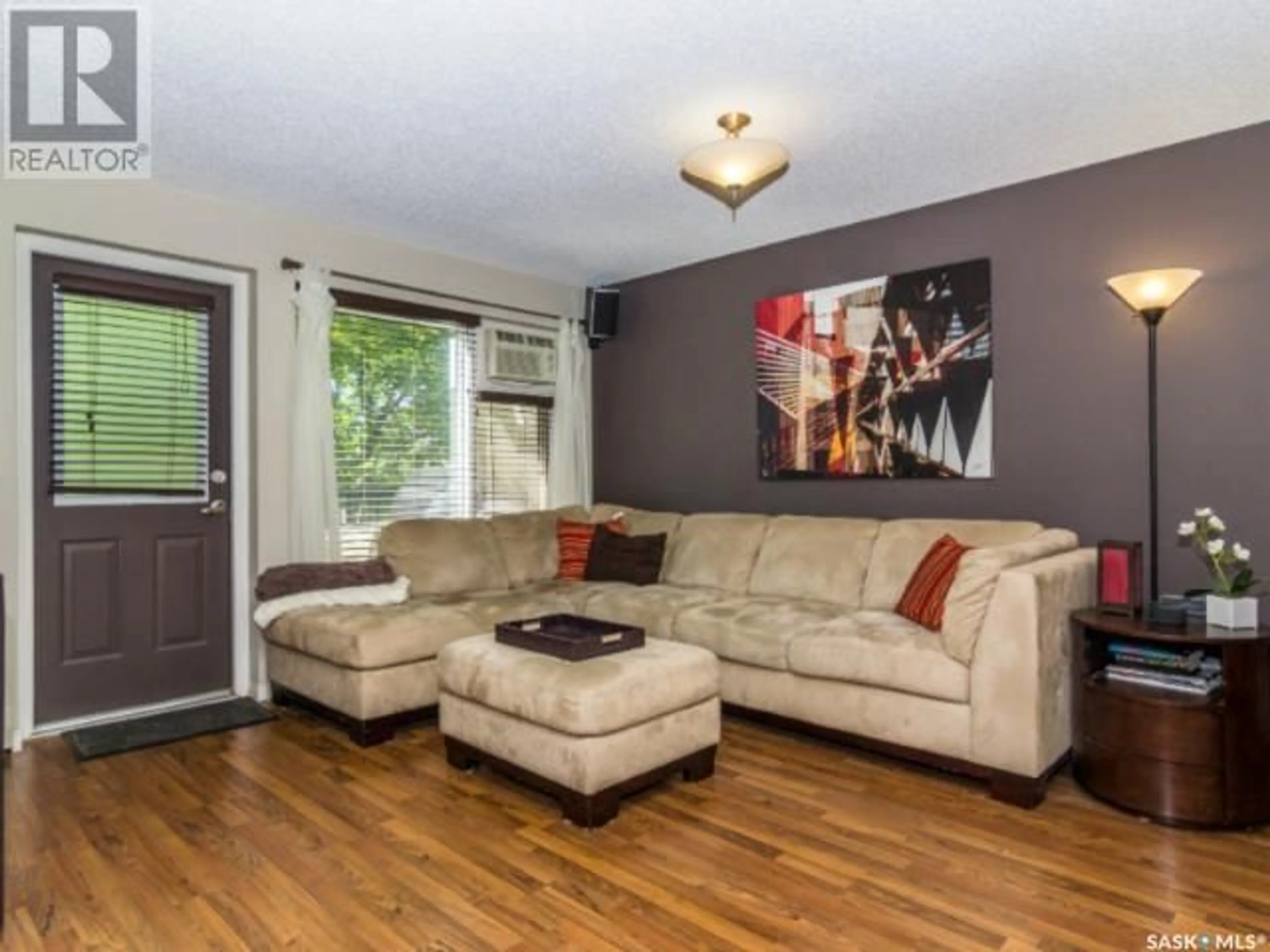 Living room with furniture, wood/laminate floor for 103 - 10 POWE STREET, Saskatoon Saskatchewan S7N1W5