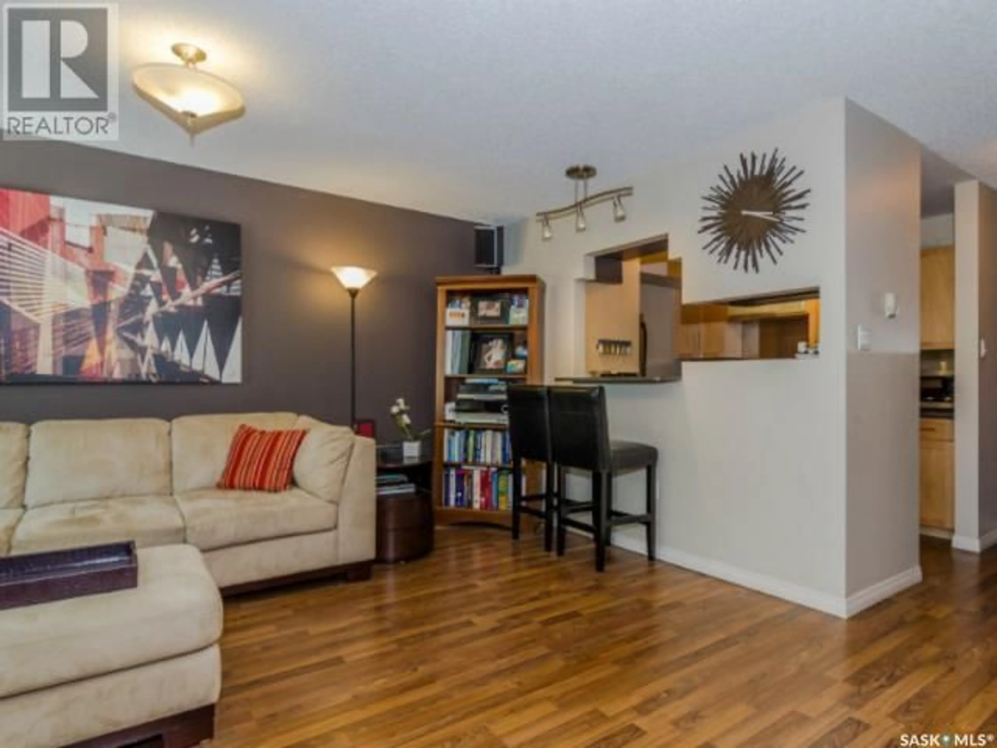 Living room with furniture, wood/laminate floor for 103 - 10 POWE STREET, Saskatoon Saskatchewan S7N1W5