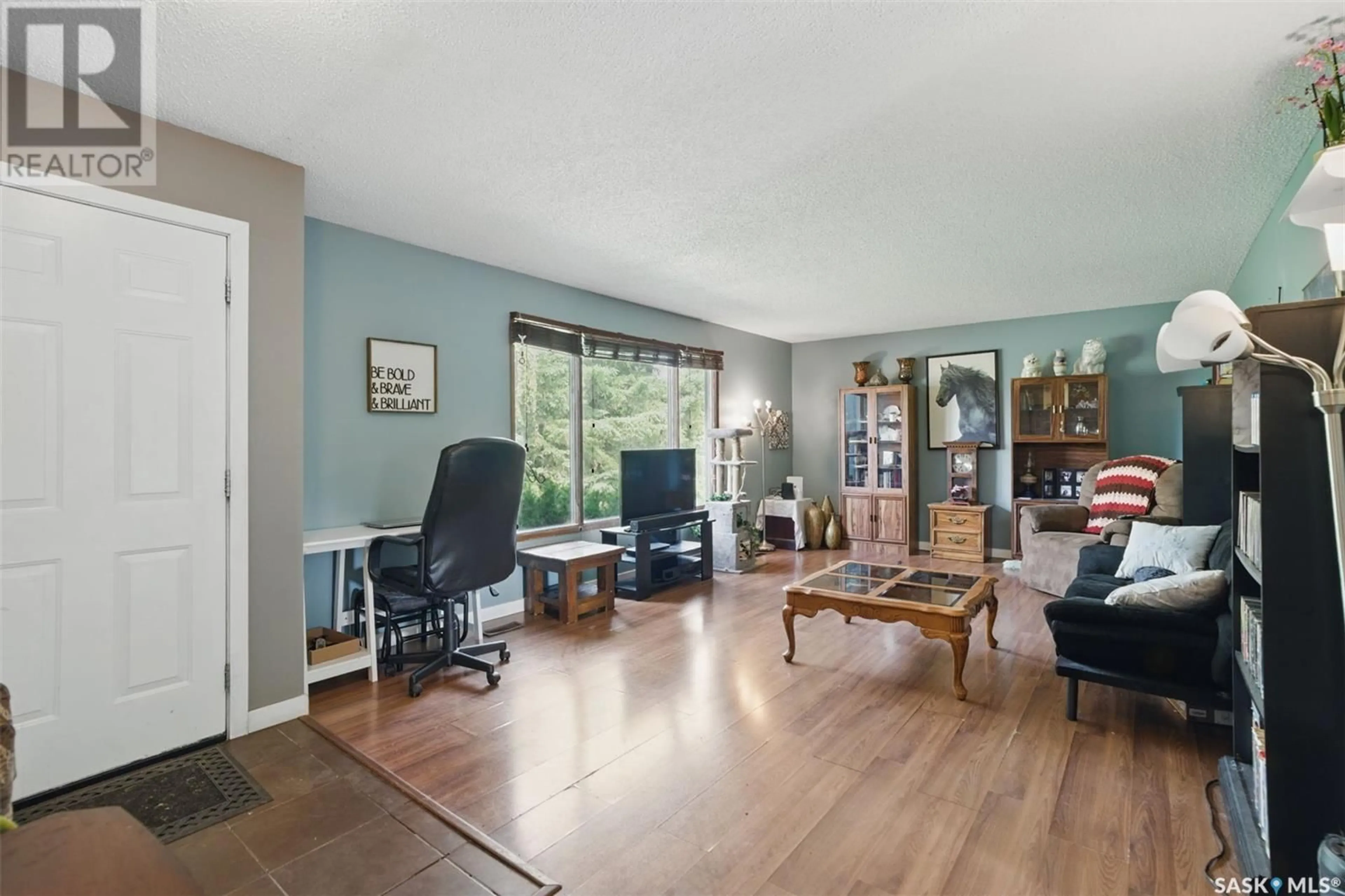 Living room with furniture, wood/laminate floor for 745 GRID ROAD, Bruno Saskatchewan S0K0S0