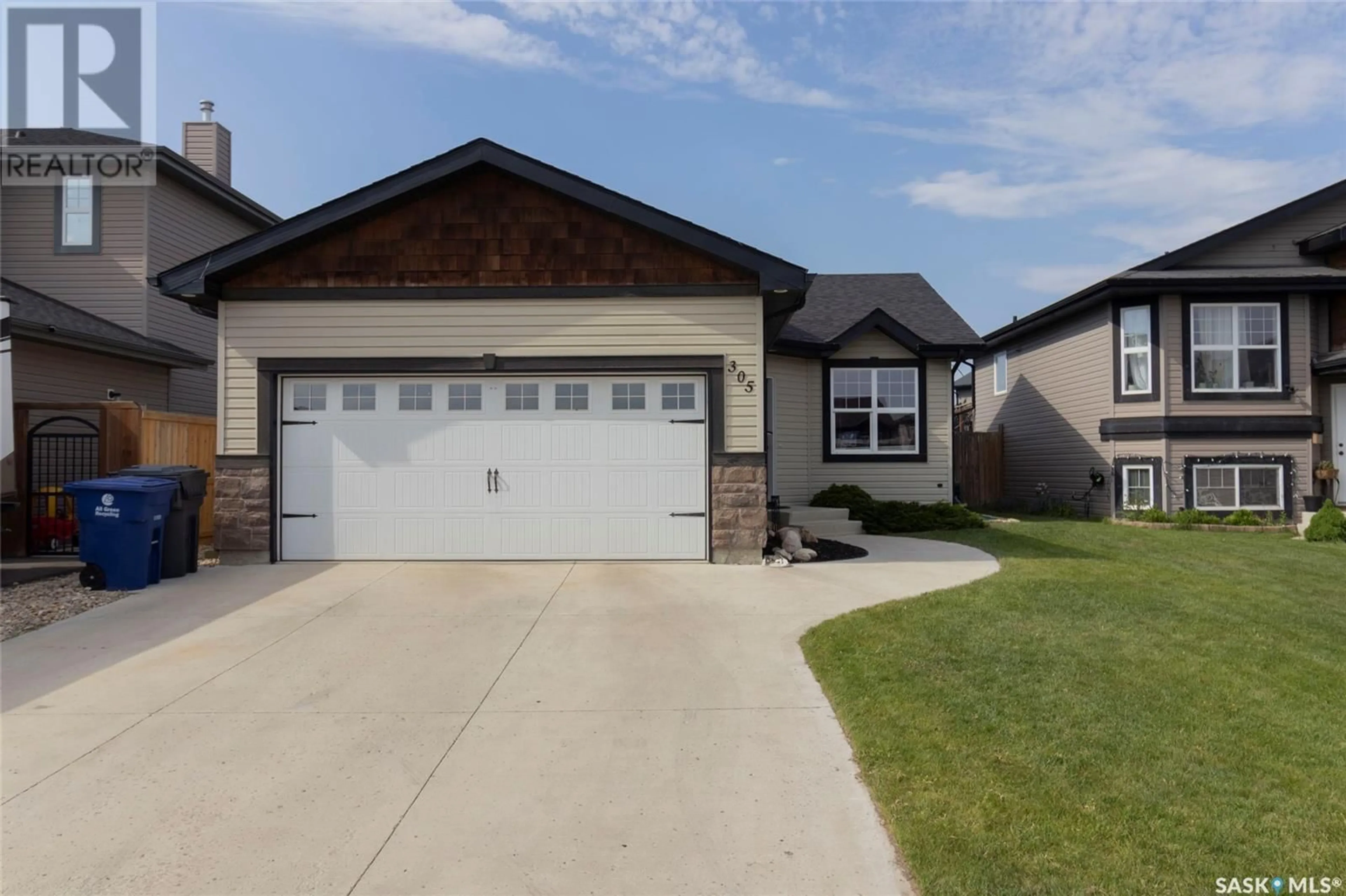 Home with vinyl exterior material, street for 305 QUESSY DRIVE, Martensville Saskatchewan S0K0A2