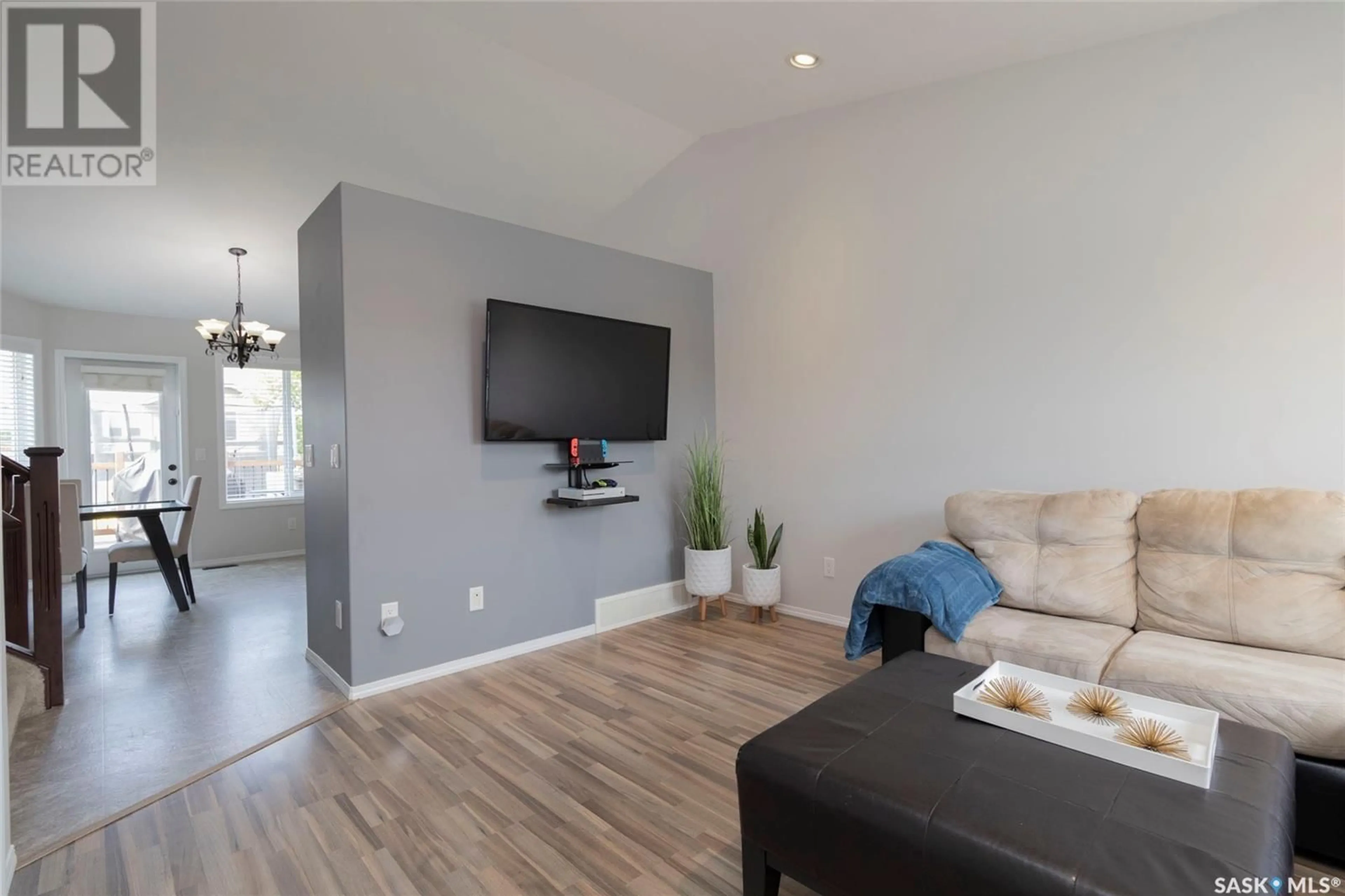 Living room with furniture, wood/laminate floor for 305 QUESSY DRIVE, Martensville Saskatchewan S0K0A2