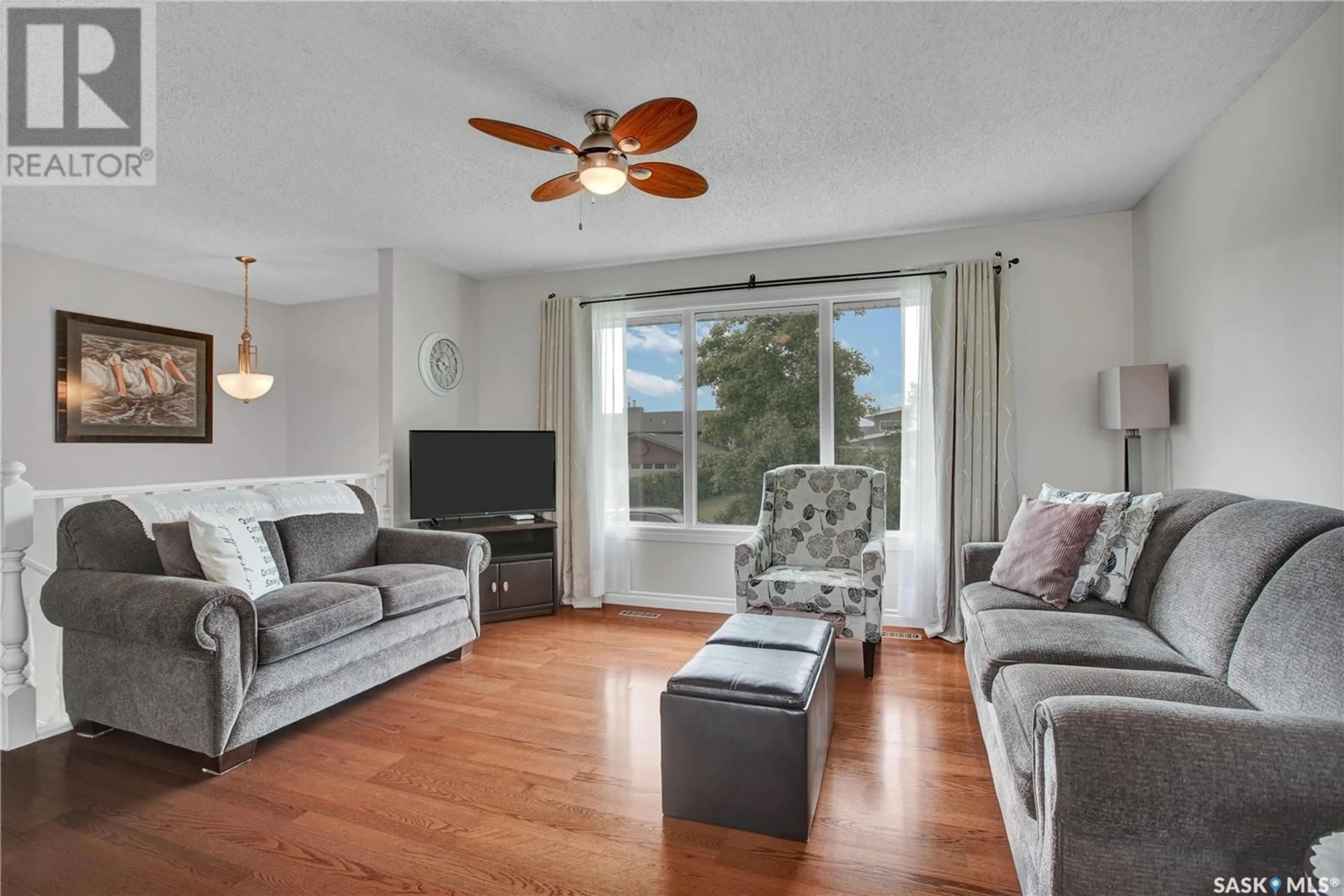 Living room with furniture, wood/laminate floor for 10 MANITOU COURT, Saskatoon Saskatchewan S7K5G3