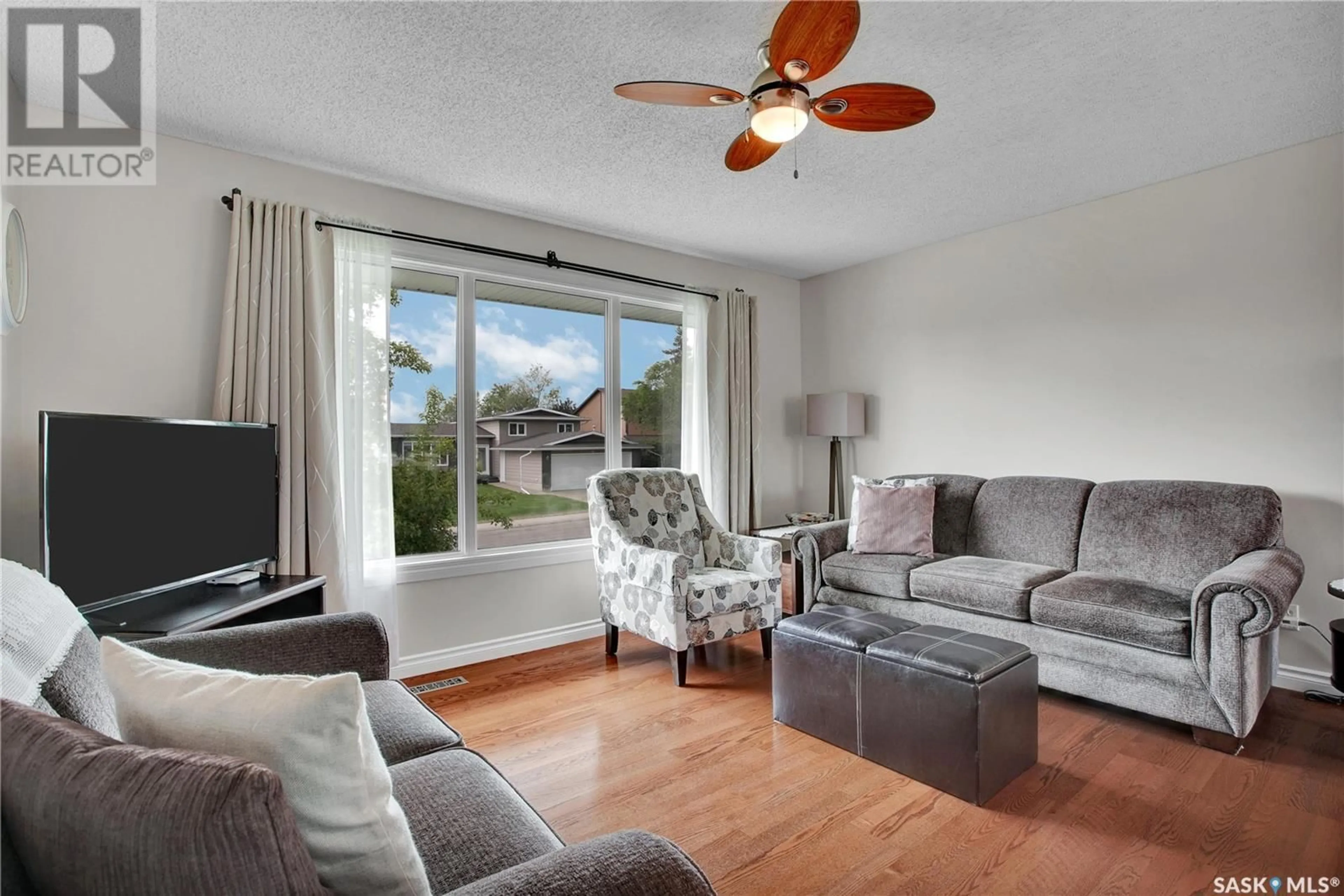 Living room with furniture, wood/laminate floor for 10 MANITOU COURT, Saskatoon Saskatchewan S7K5G3