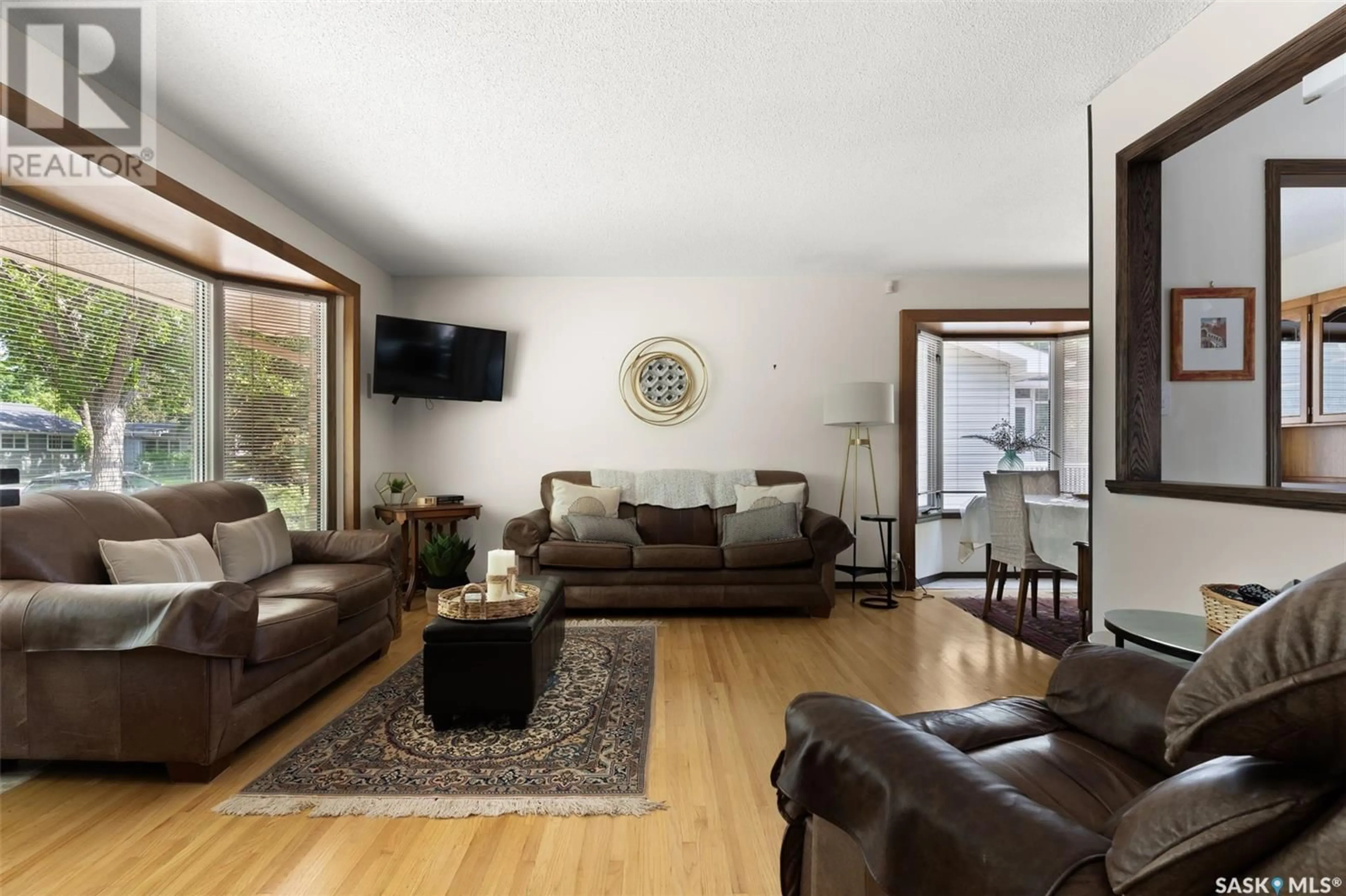 Living room with furniture, wood/laminate floor for 61 MALONE CRESCENT, Regina Saskatchewan S4S5J4
